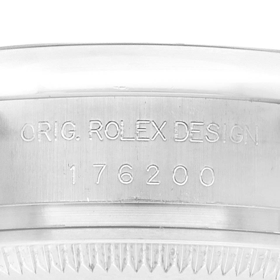 The image shows the side view of a Rolex Oyster Perpetual 176200 Women's Stainless Steel Black Dial, highlighting the engraved "ORIG. ROLEX DESIGN" and model number.