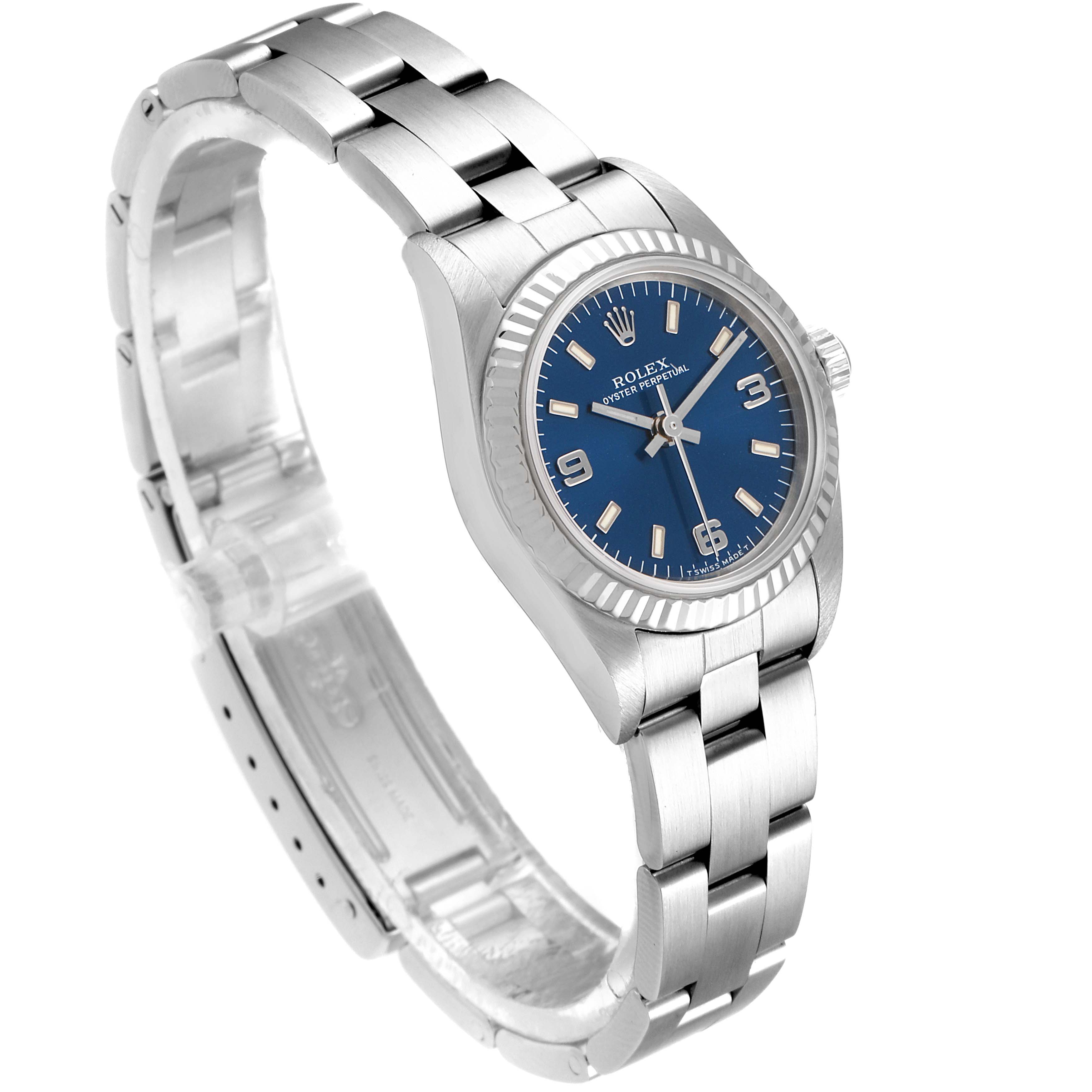The Rolex Oyster Perpetual 76094 Women
s Stainless Steel Blue Dial 76094 Women
s Stainless Steel Blue Dial watch is shown at a three-quarter angle, displaying the blue dial, case, and bracelet clearly.