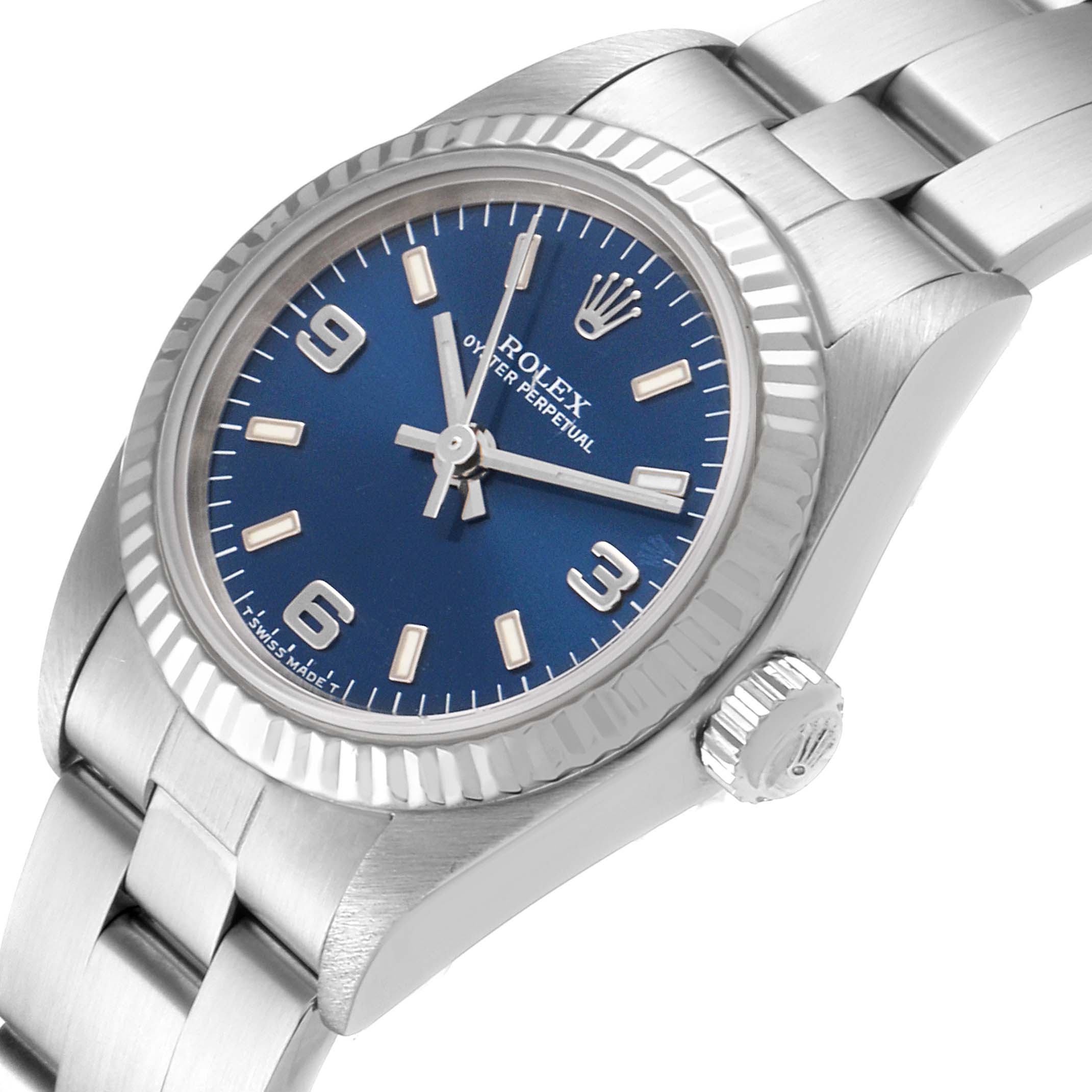 The Rolex Oyster Perpetual 76094 Women
s Stainless Steel Blue Dial 76094 Women
s Stainless Steel Blue Dial watch is shown from a slightly tilted front angle, featuring its blue dial, bezel, and part of the bracelet.