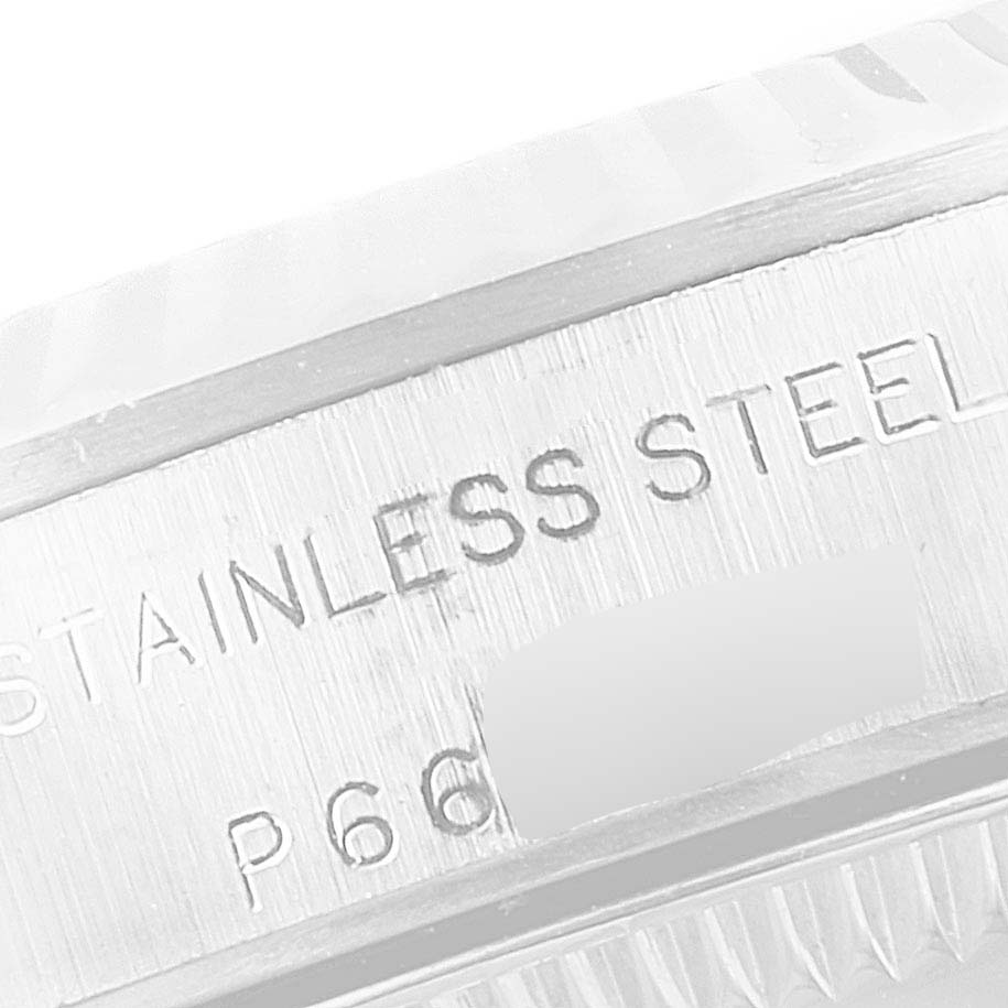 This close-up image shows the stainless steel branding and part of the bezel of a Rolex Oyster Perpetual 76094 Women
s Stainless Steel Blue Dial 76094 Women
s Stainless Steel Blue Dial watch.