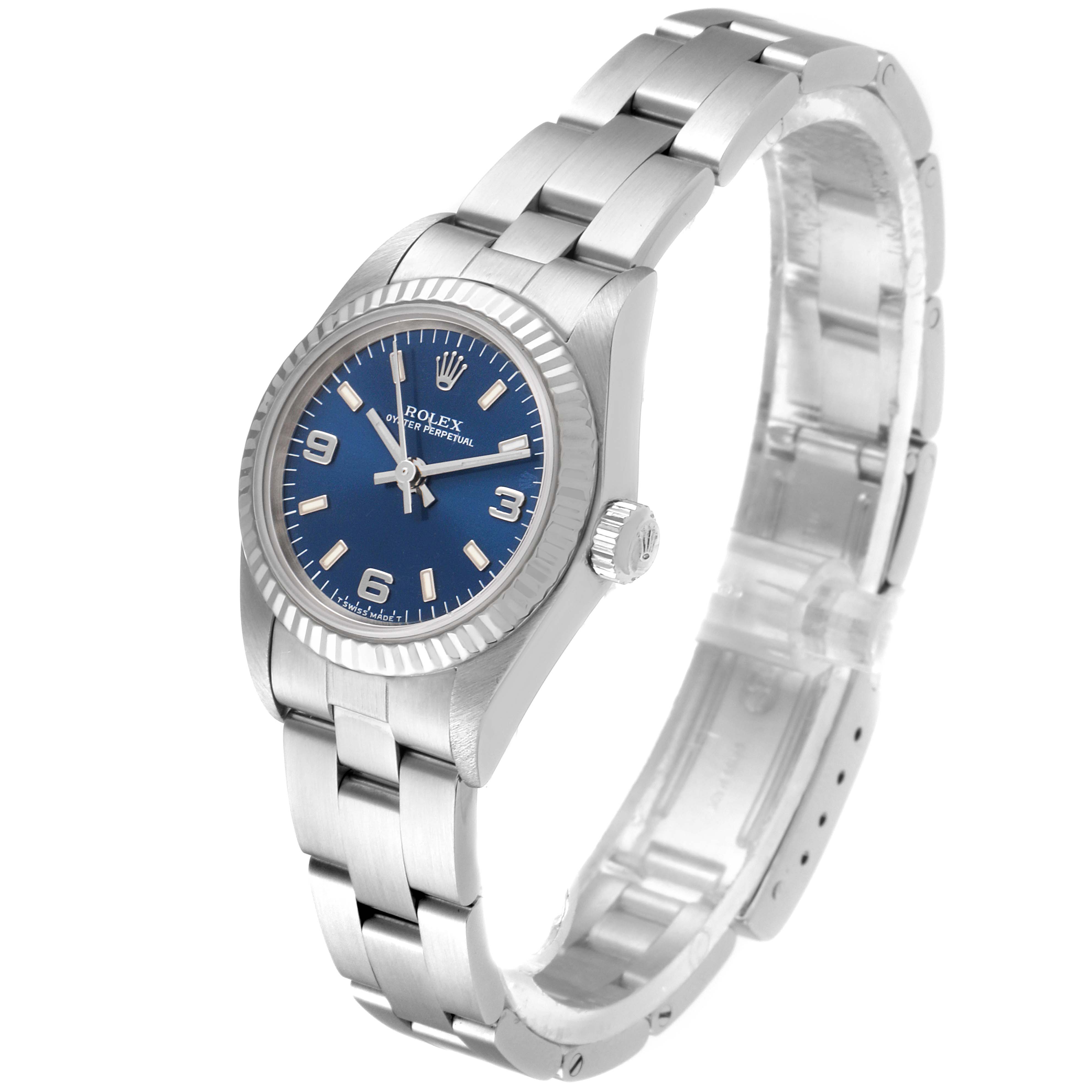 The image shows a side-angle view of the Rolex Oyster Perpetual 76094 Women
s Stainless Steel Blue Dial 76094 Women
s Stainless Steel Blue Dial watch, highlighting the blue dial, bezel, lugs, bracelet, and clasp.