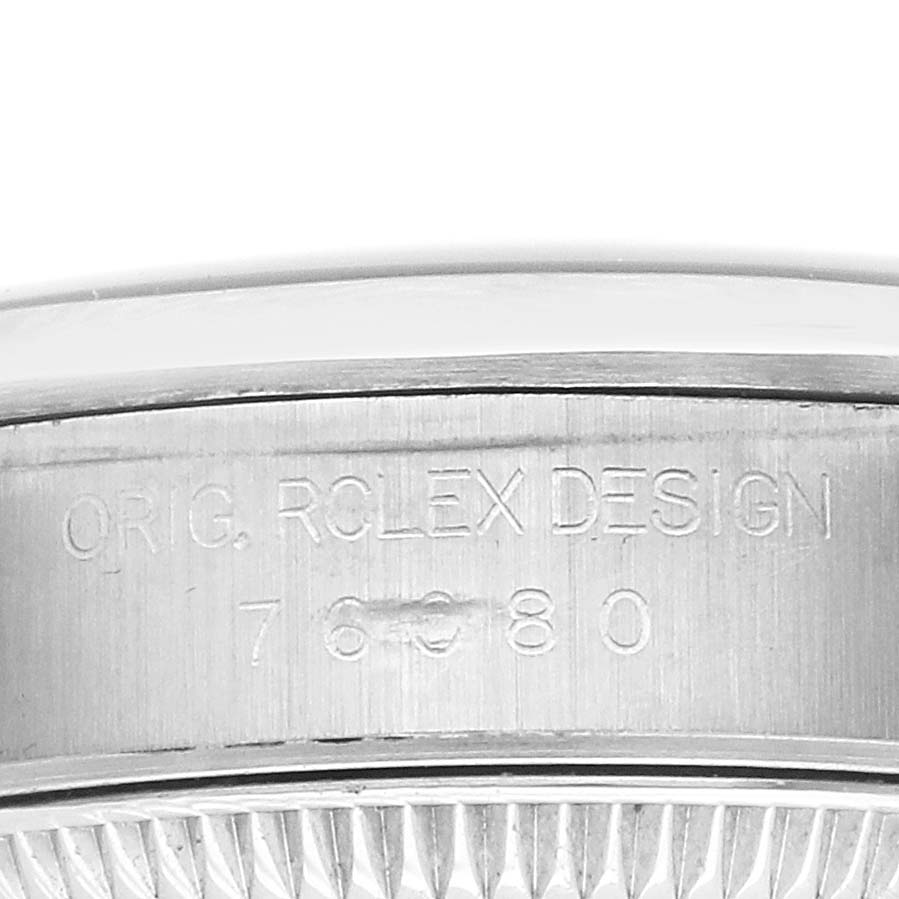 The image shows the side engraving on a Rolex Datejust 76080 Women's Stainless Steel Black Dial watch case with model and design details.