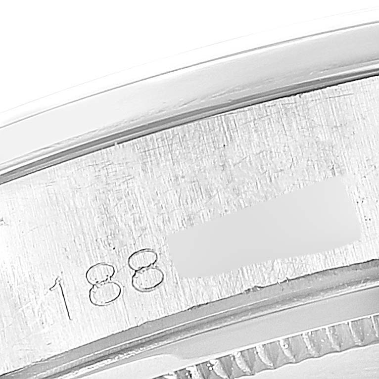 The image shows a close-up of the engraved serial number on the edge of the Vintage Collection model by Rolex.