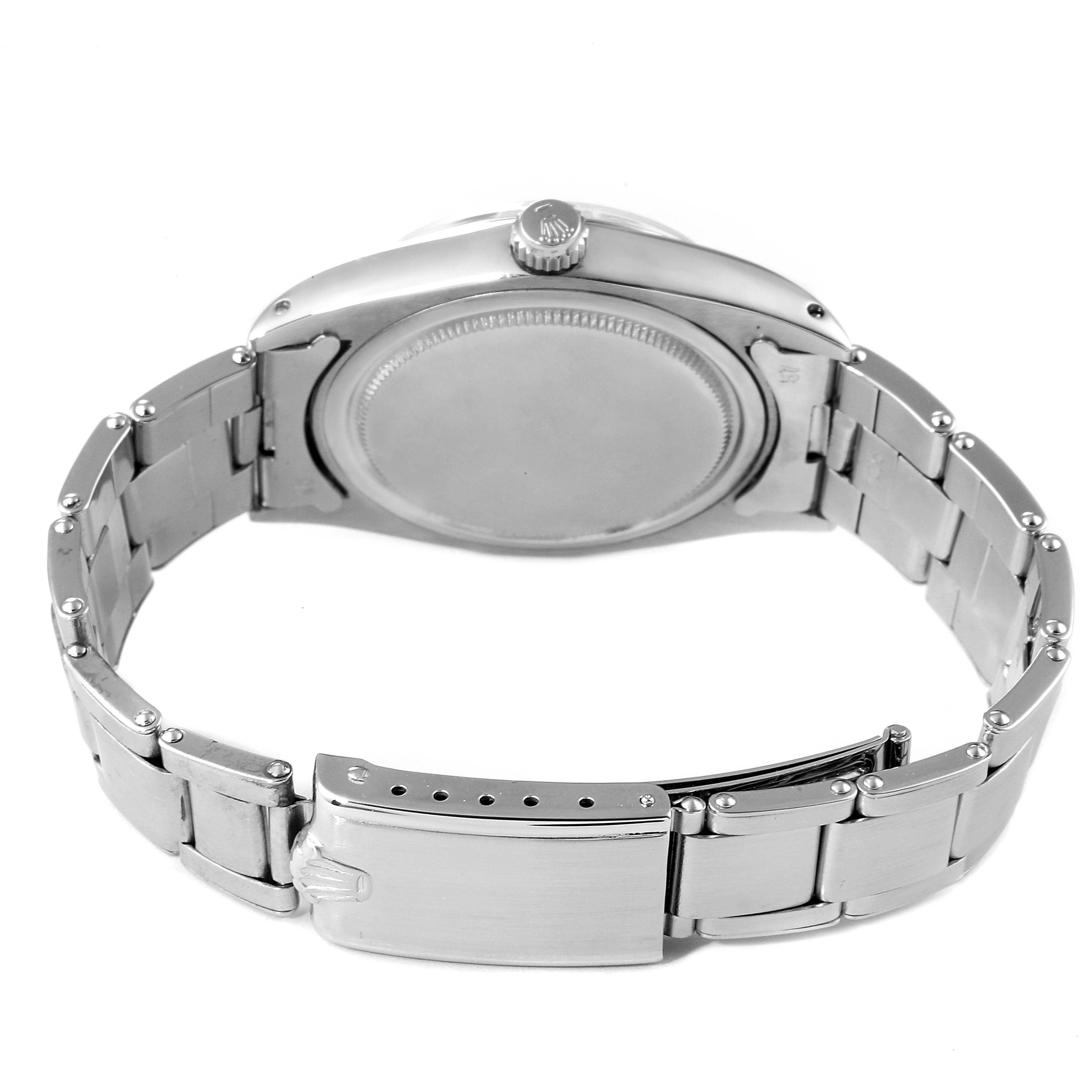 The image shows the back view of a Rolex Vintage Collection 6694 Men's Stainless Steel Black Dial 6694 Men's Stainless Steel Black Dial model watch, highlighting the case back, crown, and bracelet clasp.