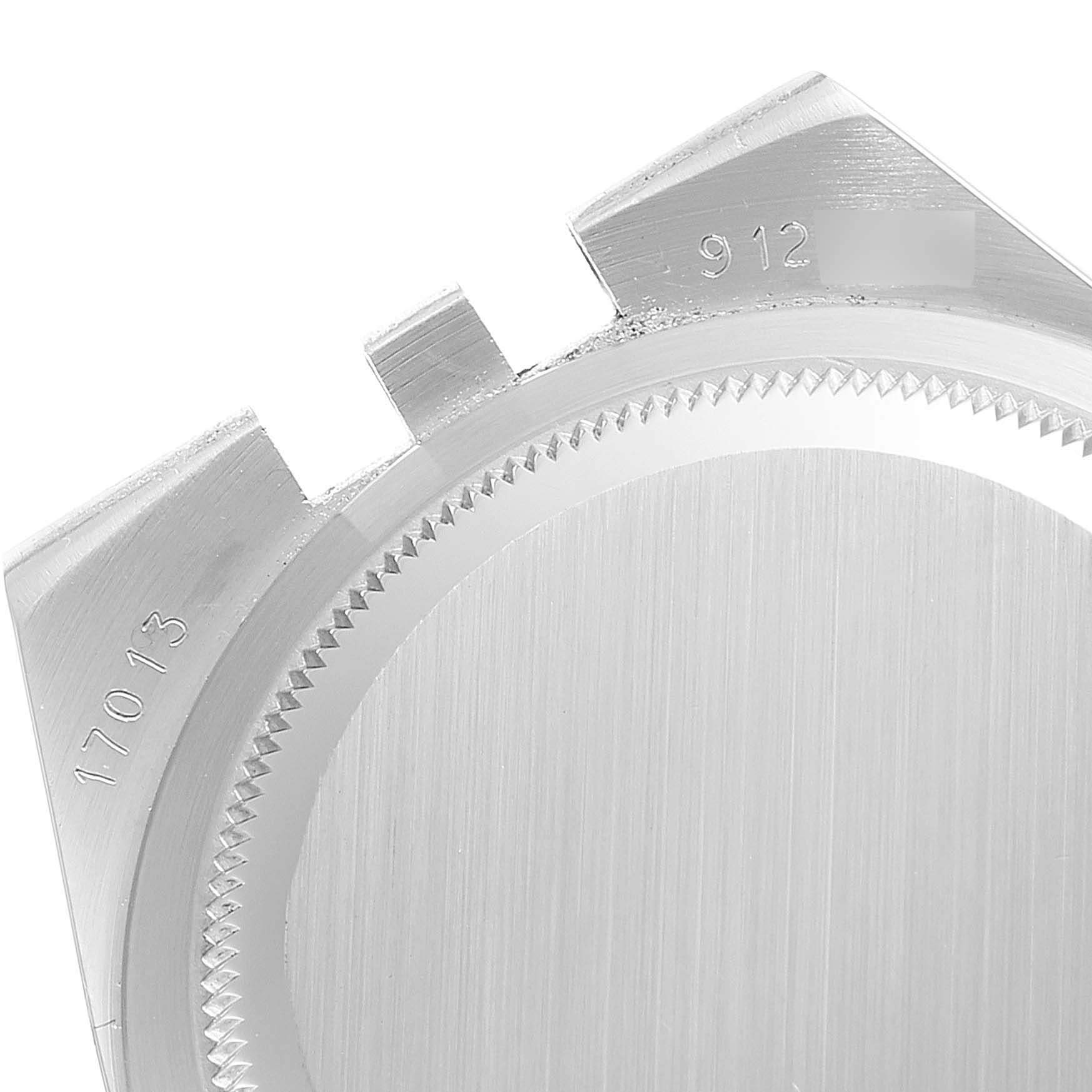 The image shows a close-up angle of the case back of the Rolex Oysterquartz 17013 Men's Steel and Gold (two tone) Champagne Dial 17013 Men's Steel and Gold (two tone) Champagne Dial model, displaying part numbers and tooth edges.