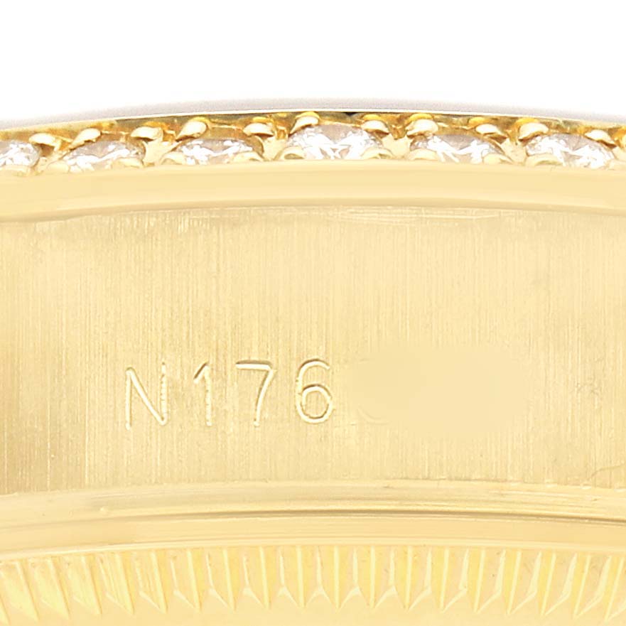 This image shows a close-up of the side bezel and edge of a Rolex President 69268 Women's Yellow Gold Champagne Dial watch, featuring engravings and diamond detailing.