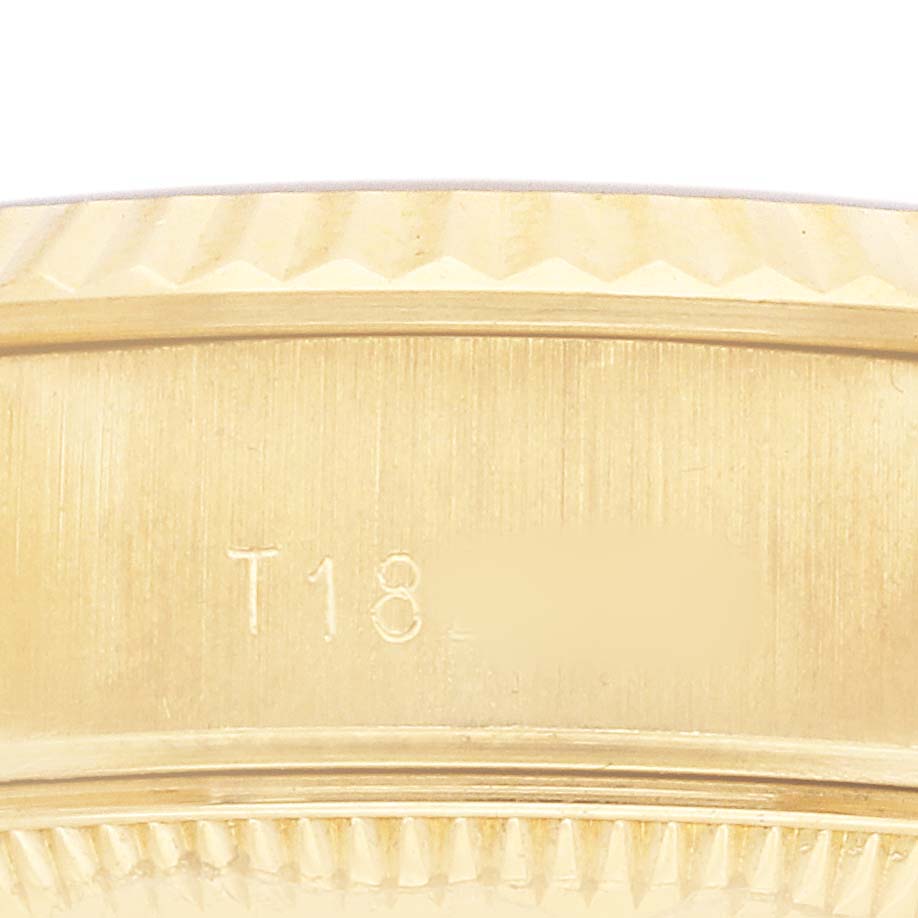 The image shows a close-up of the side of a Rolex President 69178 Women's Yellow Gold Champagne Dial watch, featuring its gold case with engraved details.