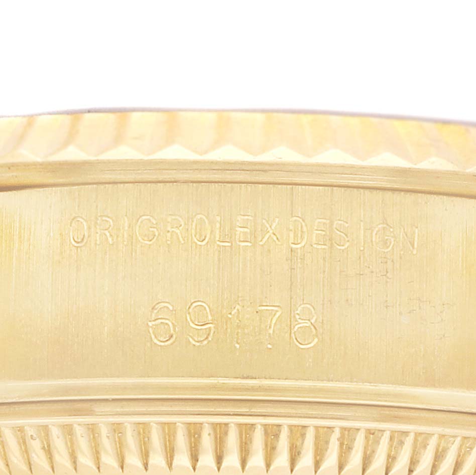 The image shows the engraved side of a Rolex President 69178 Women's Yellow Gold Champagne Dial watch model 69178, focusing on the serial and model numbers.