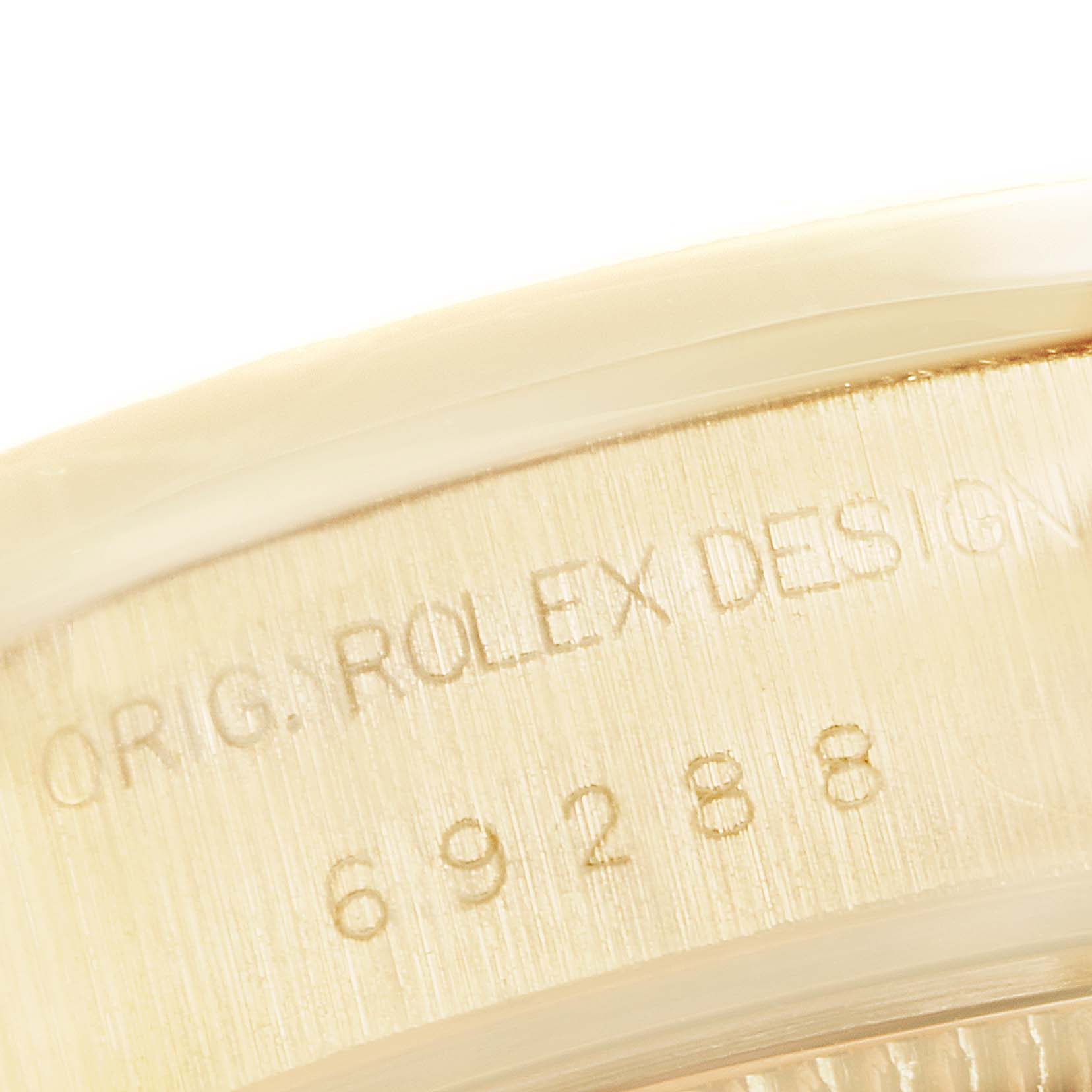 This image shows a close-up of the engraving on the case back of a Rolex President 69288 Women's Yellow Gold Mother of Pearl Dial 69288 Women's Yellow Gold Mother of Pearl Dial model watch.