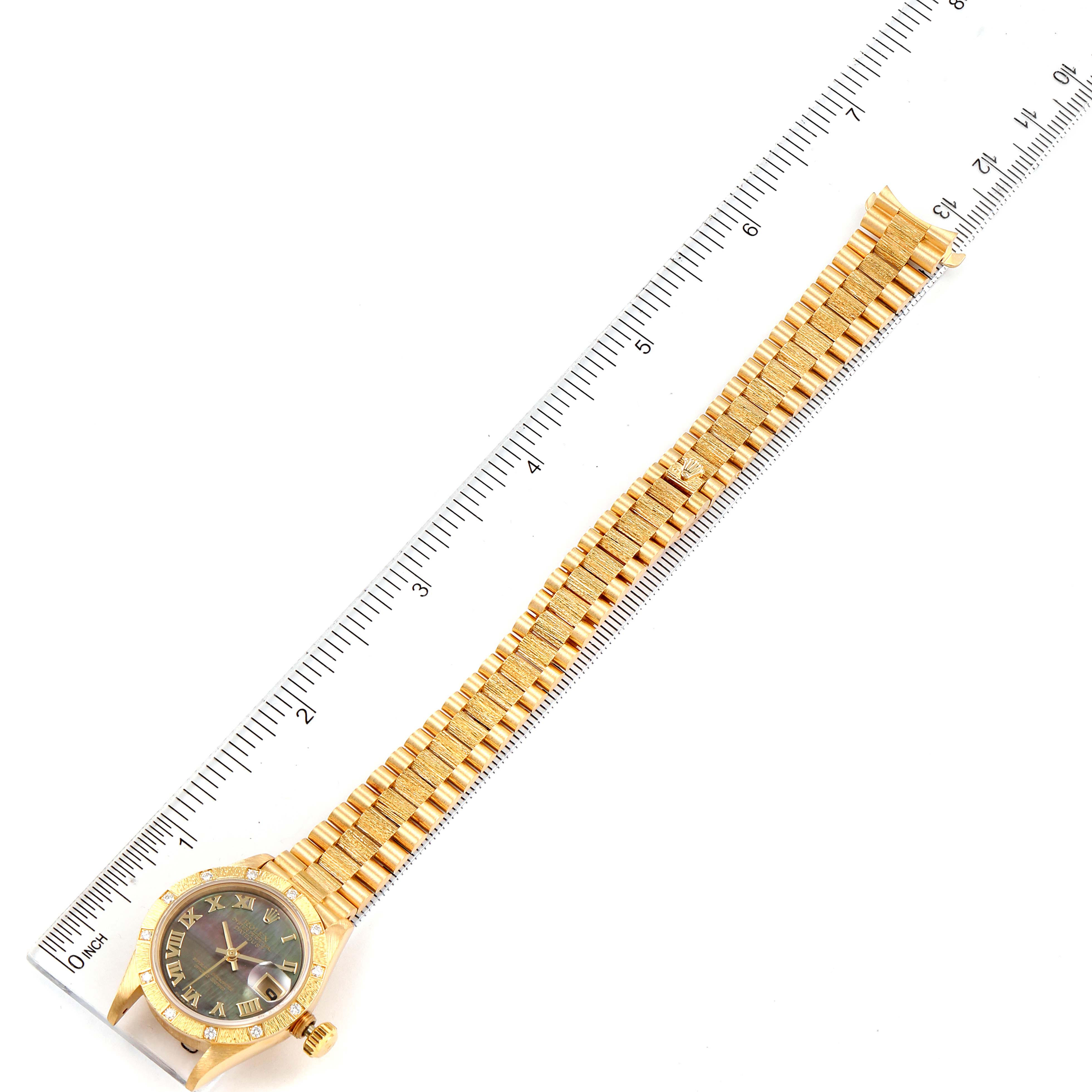 The image shows the full length of a Rolex President 69288 Women's Yellow Gold Mother of Pearl Dial 69288 Women's Yellow Gold Mother of Pearl Dial model watch, including the face, band, and a measuring ruler for scale.
