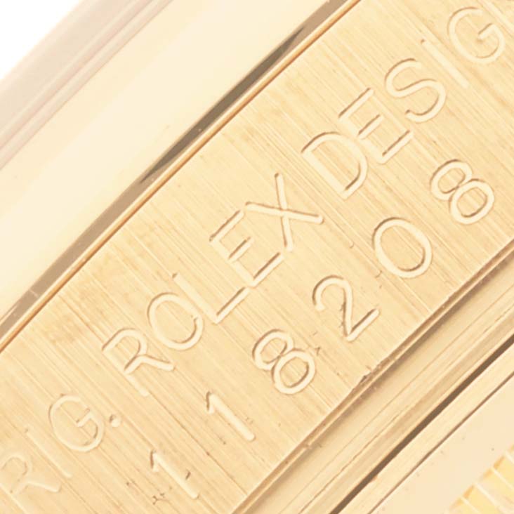 The image shows a close-up of the engraved side of a Rolex President 118208 Men
s Yellow Gold Mother of Pearl Dial 118208 Men
s Yellow Gold Mother of Pearl Dial model watch, highlighting the brand and model details.