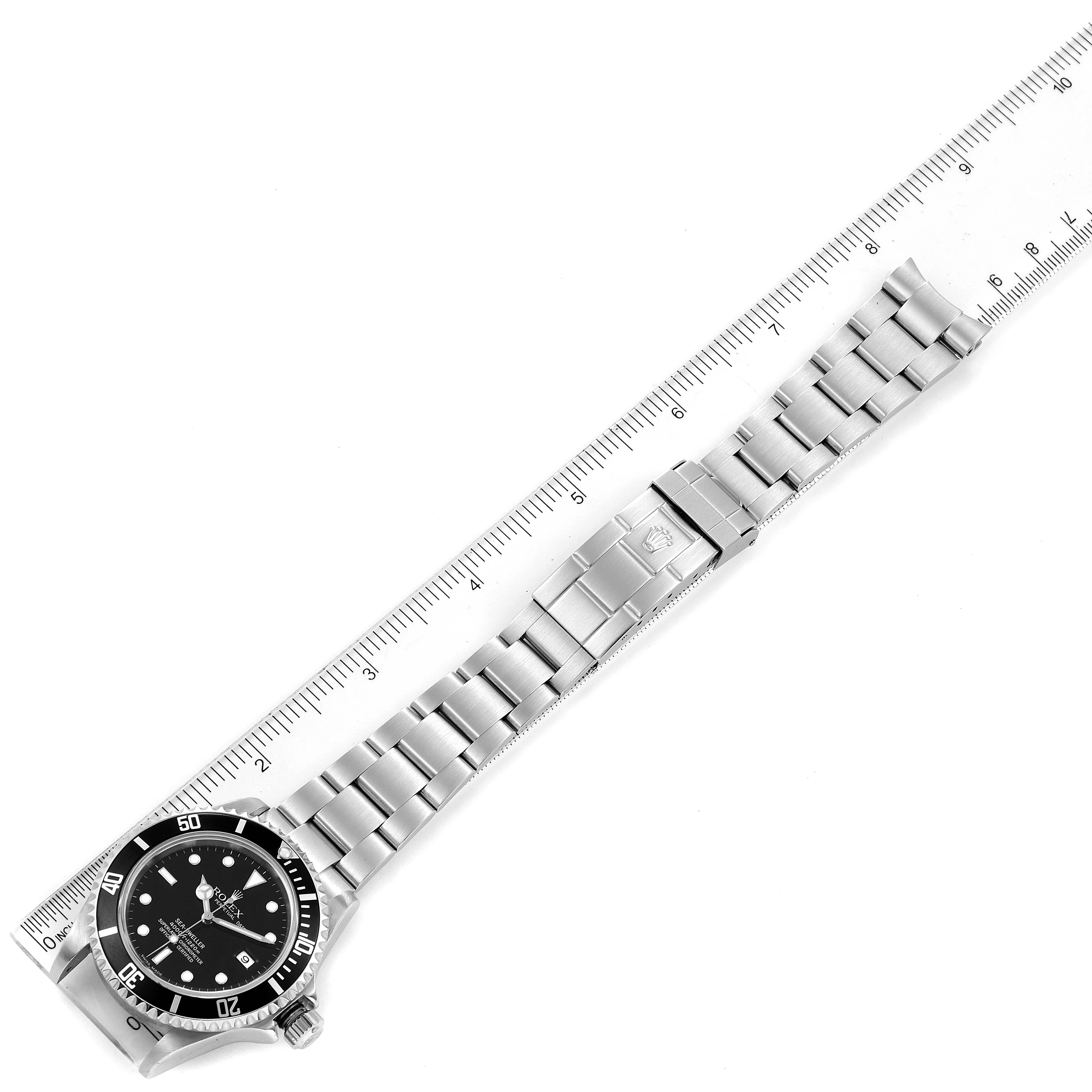 The Rolex Sea-Dweller 16600 Men's Stainless Steel Black Dial 16600 Men's Stainless Steel Black Dial watch is shown from a top-down angle, displaying the face, bezel, and full bracelet alongside a ruler.