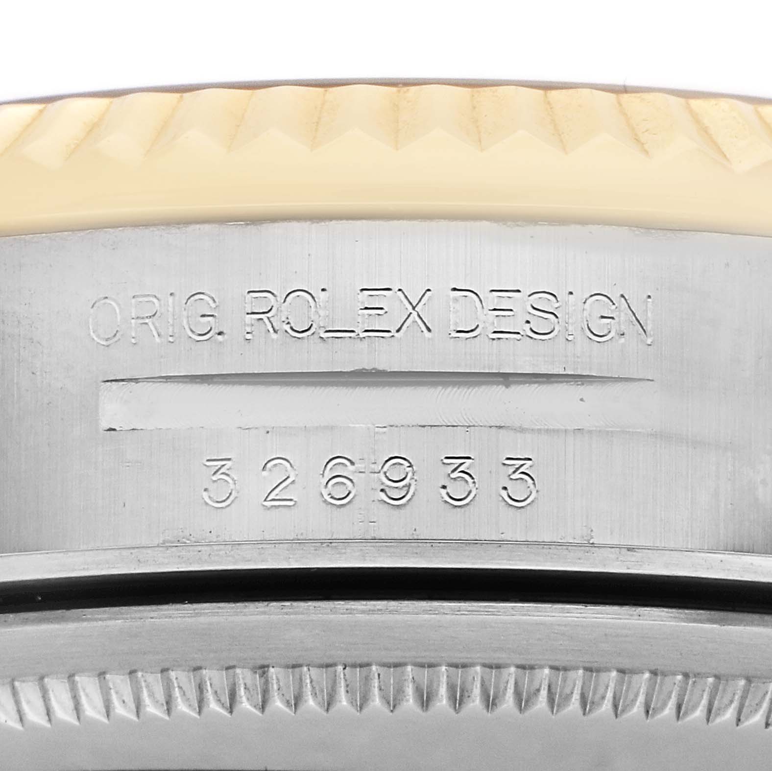 The image shows a close-up of the side of a Rolex Sky-Dweller 326933 Men's Steel and Gold (two tone) White Dial, highlighting the engraved model number and fluted bezel.