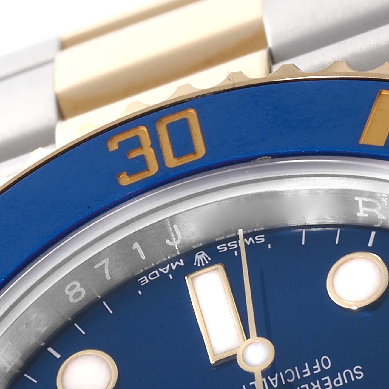 Close-up view of the Rolex Submariner 126613 Men's Steel and Gold (two tone) Blue Dial 126613 Men's Steel and Gold (two tone) Blue Dial model showing part of the blue bezel and dial with the 30-minute marker.