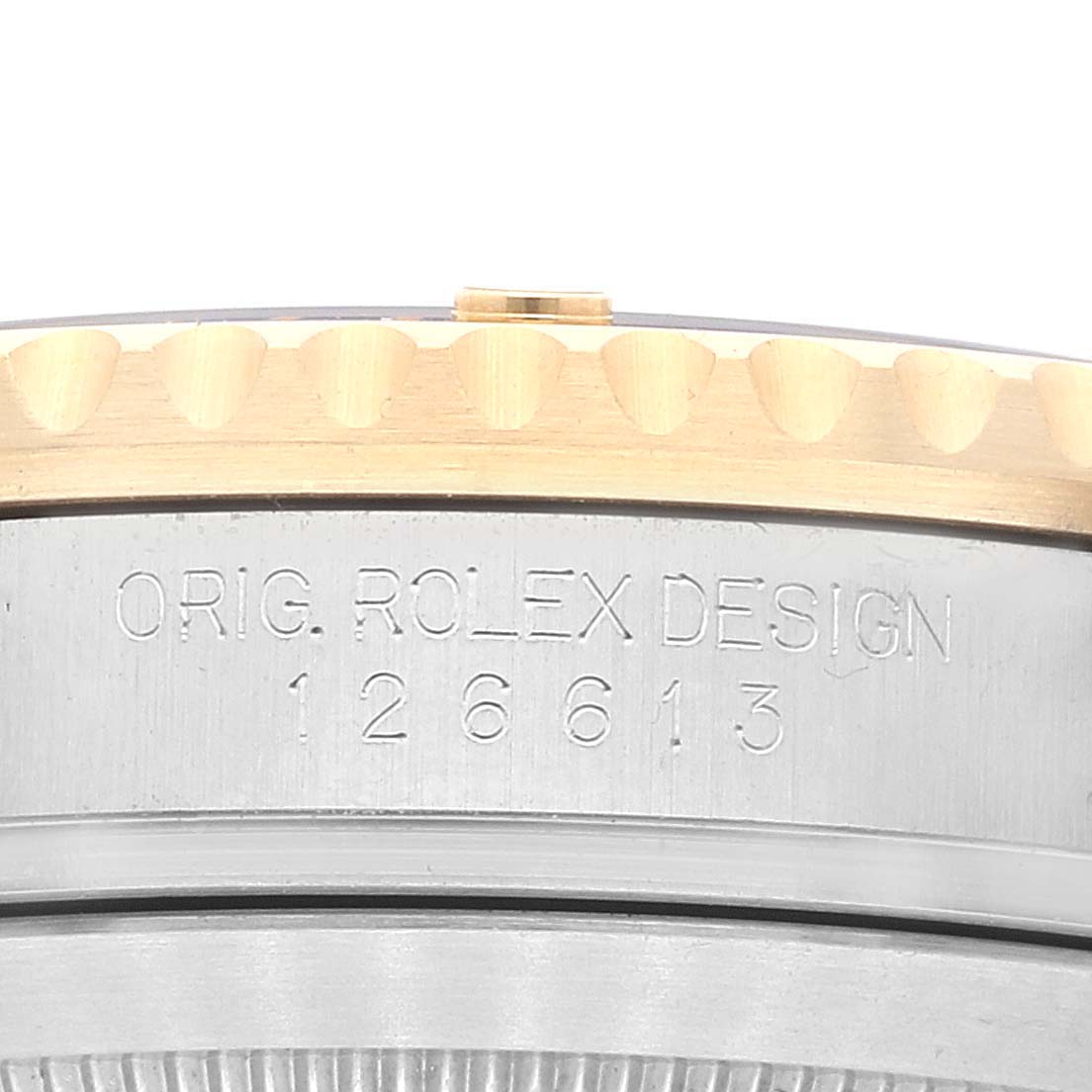 The image displays a close-up of the side of a Rolex Submariner 126613 Men's Steel and Gold (two tone) Blue Dial 126613 Men's Steel and Gold (two tone) Blue Dial watch, showing the engraved model number "126613" and the text "ORIG. ROLEX DESIGN."