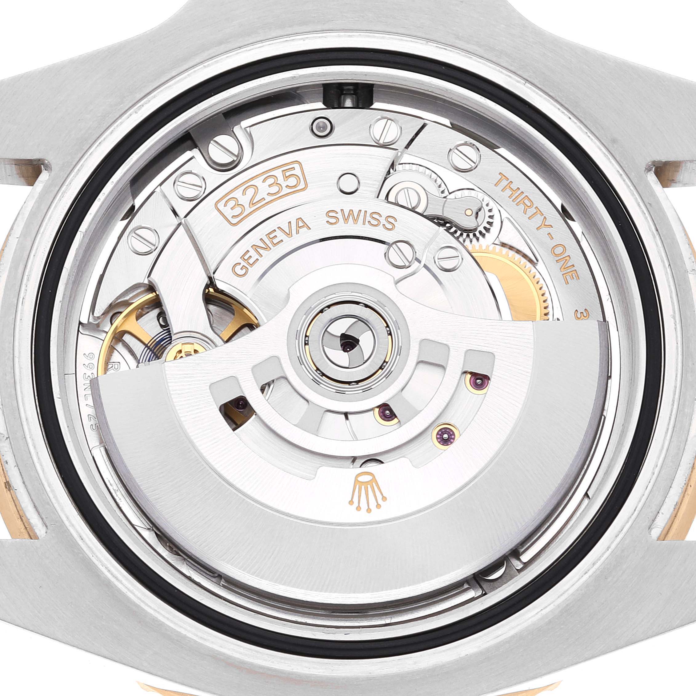 This image shows an up-close view of the Rolex Submariner 126613 Men's Steel and Gold (two tone) Blue Dial 126613 Men's Steel and Gold (two tone) Blue Dial's movement and inner mechanical parts.