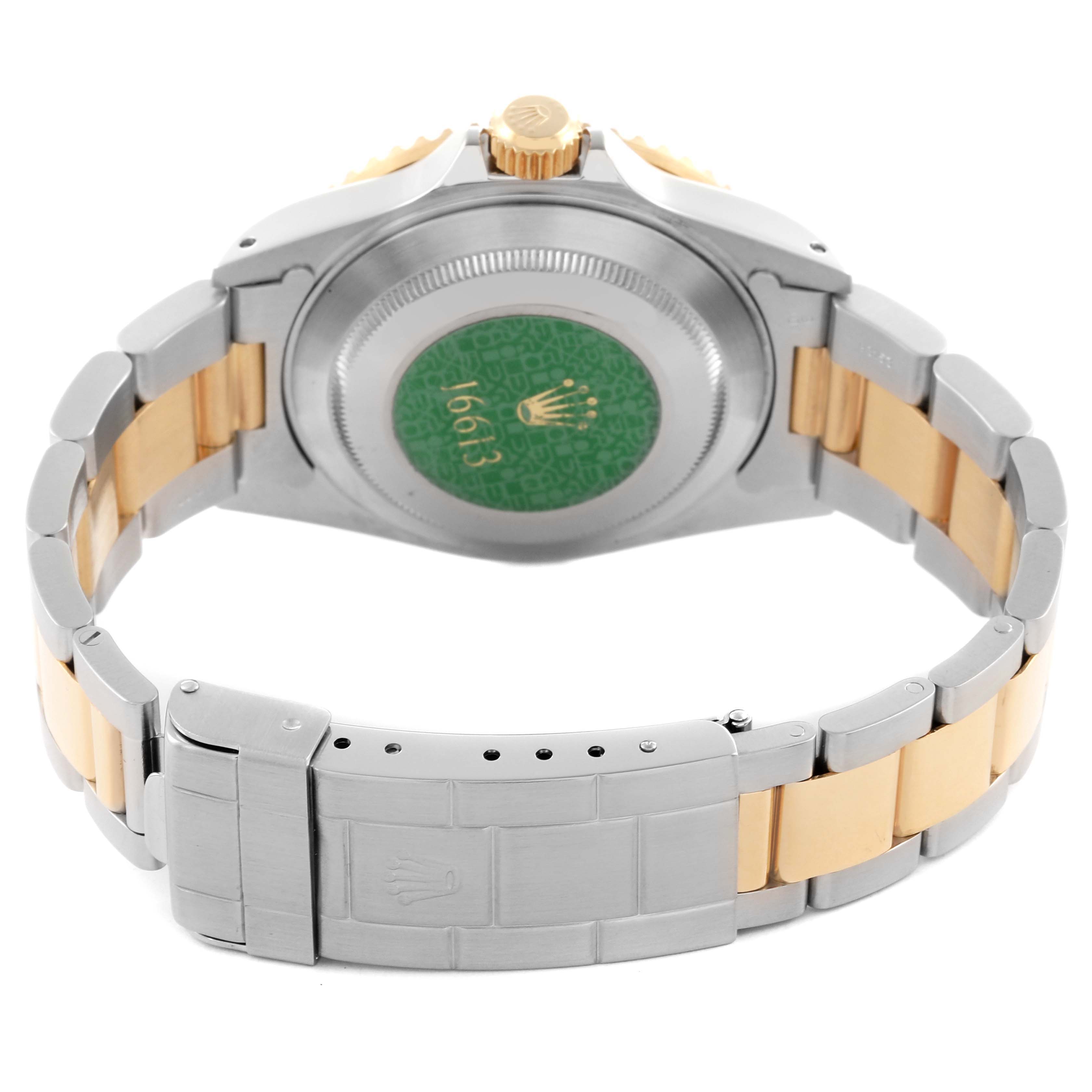 The image shows the back of a Rolex Submariner 16613 Men's Steel and Gold (two tone) Blue Dial 16613 Men's Steel and Gold (two tone) Blue Dial, highlighting the case back, crown, and bracelet clasp.