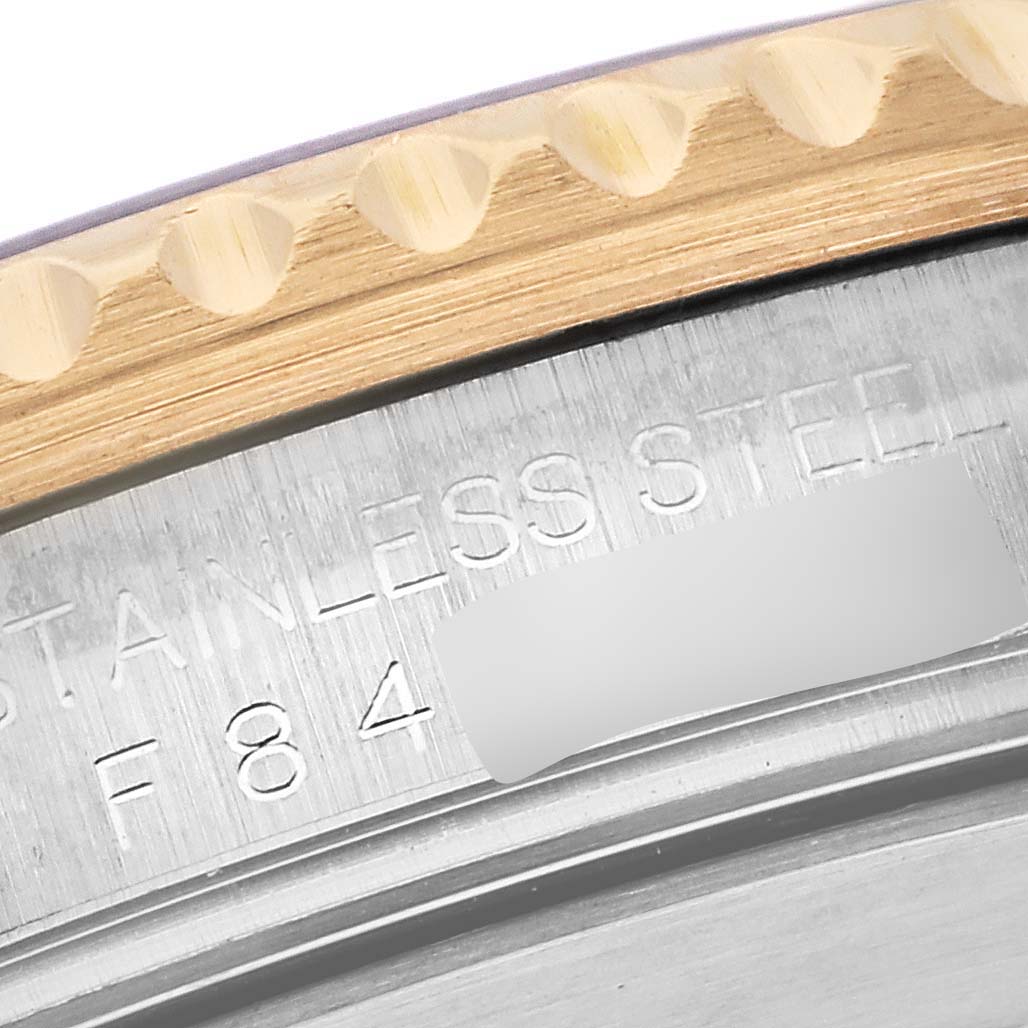 The image shows a close-up of the case back and edge of the bezel of a Rolex Submariner 16613 Men's Steel and Gold (two tone) Blue Dial 16613 Men's Steel and Gold (two tone) Blue Dial.