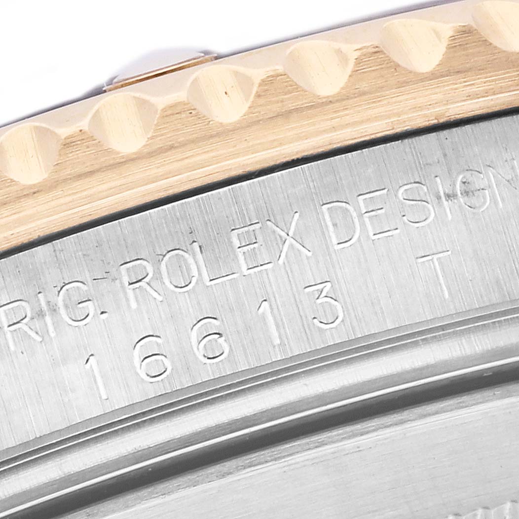 The image shows a close-up of the side case and engraved model number of a Rolex Submariner 16613 Men's Steel and Gold (two tone) Blue Dial 16613 Men's Steel and Gold (two tone) Blue Dial.