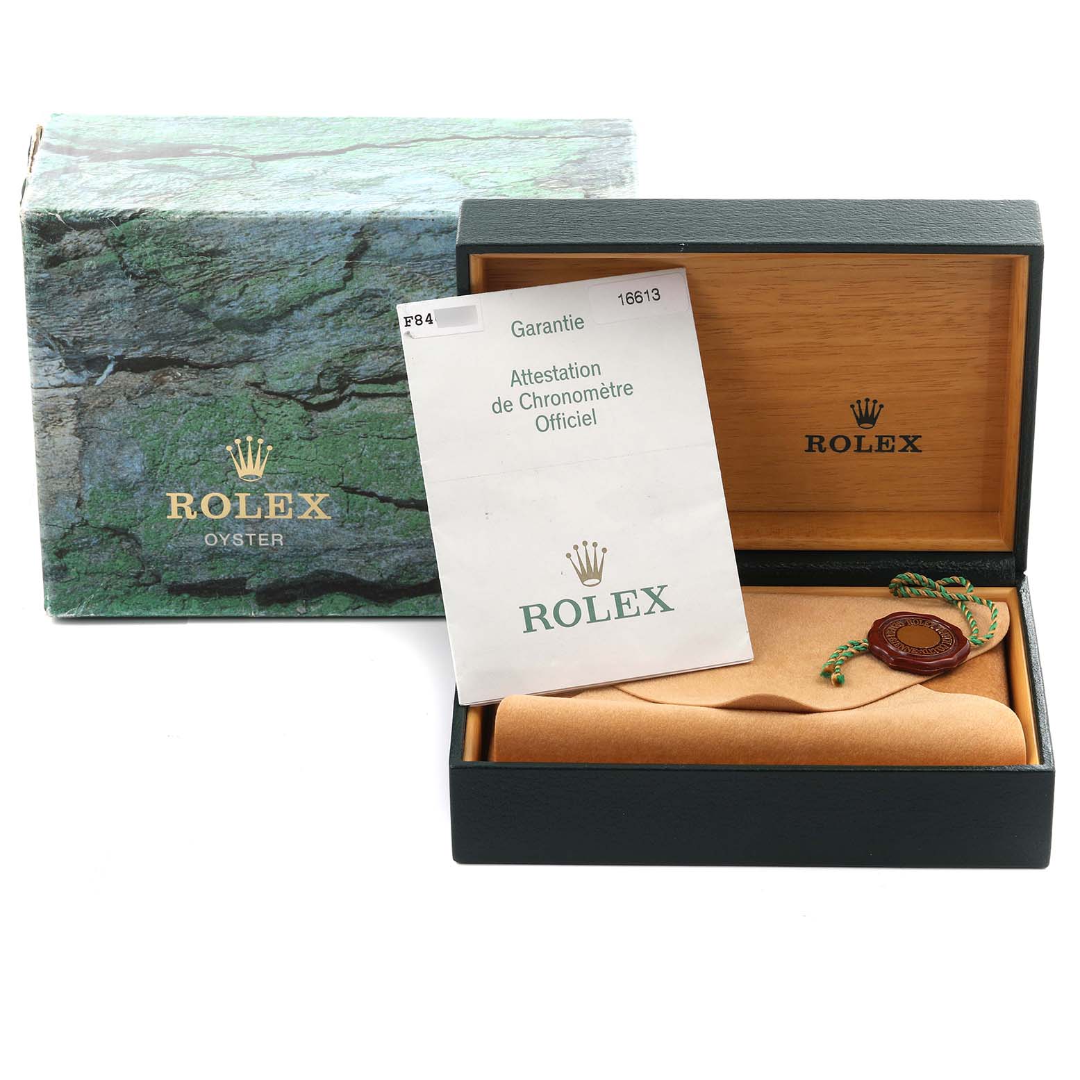 The image shows the Rolex Submariner 16613 Men's Steel and Gold (two tone) Blue Dial 16613 Men's Steel and Gold (two tone) Blue Dial box, warranty card, and green seal from a frontal angle.