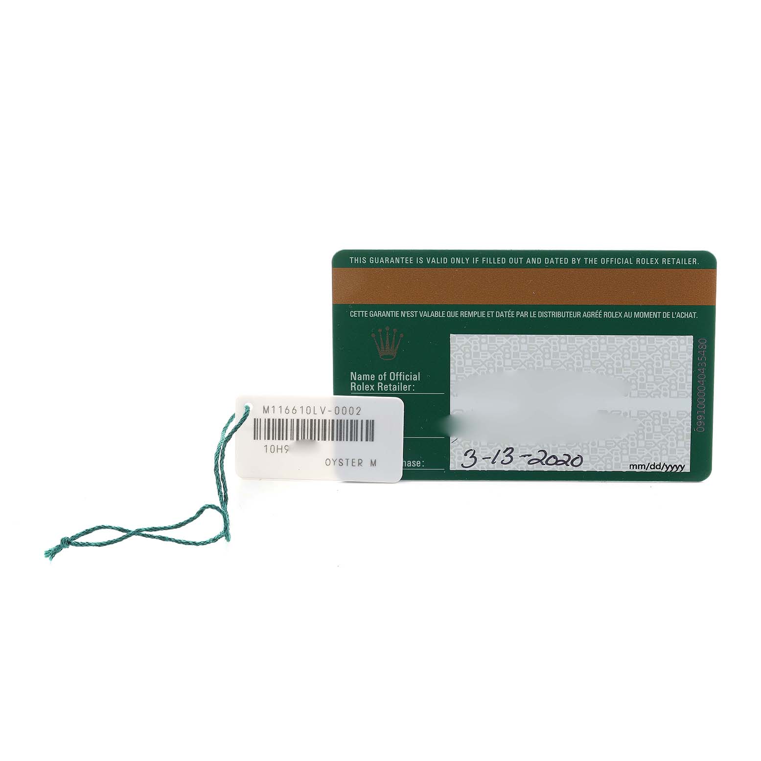 The image shows a guarantee card and attached tag for the Rolex Submariner 116610LV Men's Stainless Steel Green Dial model, viewed from above.