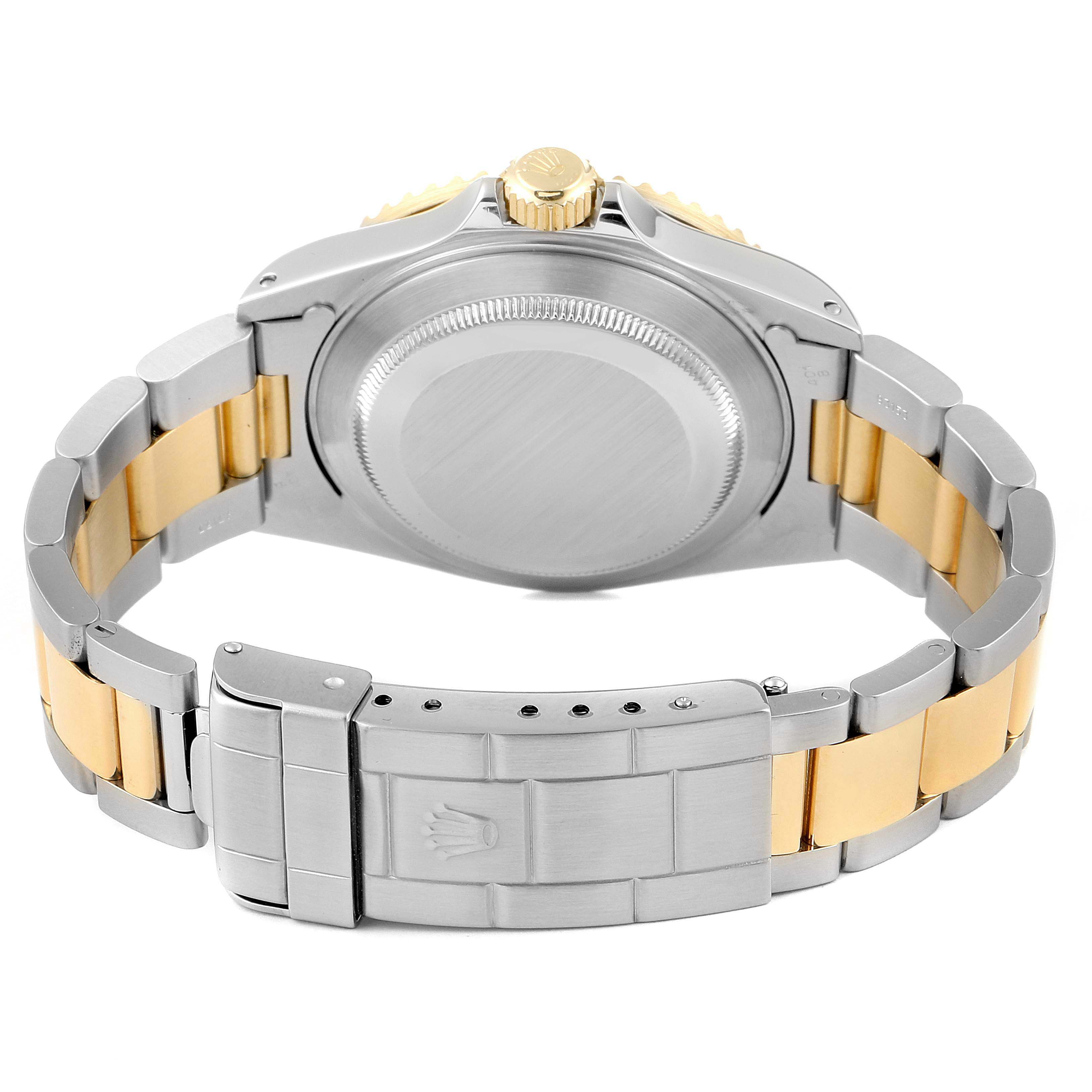 The image shows the back case and bracelet of a Rolex Submariner 16613 Men's Steel and Gold (two tone) Blue Dial 16613 Men's Steel and Gold (two tone) Blue Dial watch, highlighting its two-tone metal design.