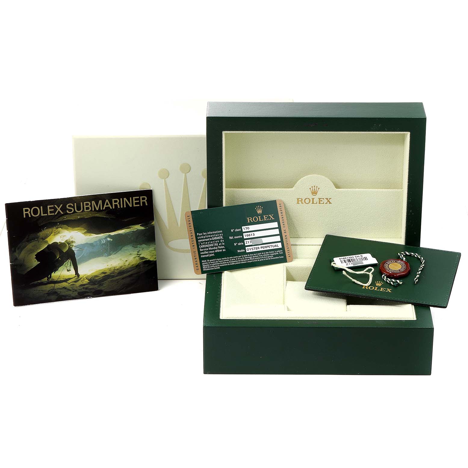 The image shows a Rolex Submariner 16613 Men's Steel and Gold (two tone) Champagne Dial 16613 Men's Steel and Gold (two tone) Champagne Dial's box, warranty card, booklet, hang tag, and accessory pouch from a front angle.
