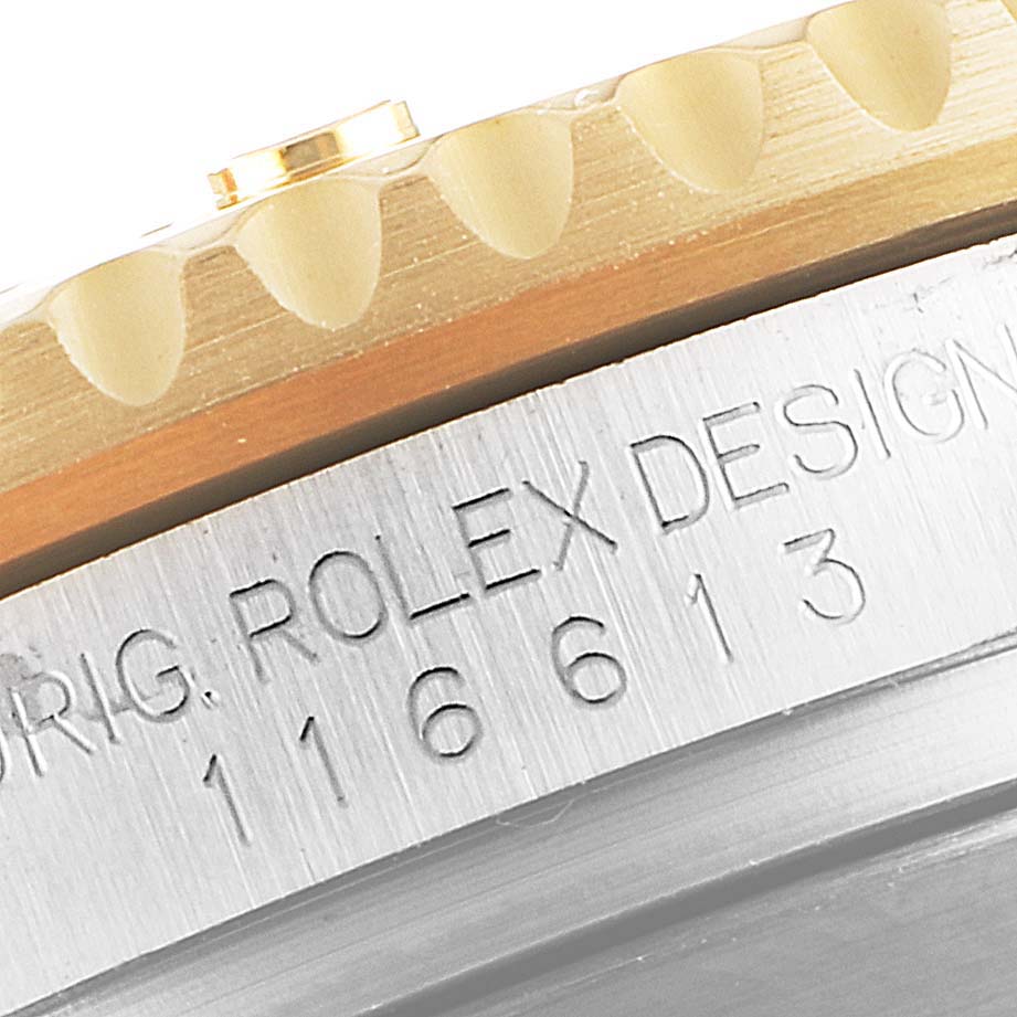 This close-up angle shows the engraved side of the bezel and case of a Rolex Submariner 116613 Men
s Steel and Gold (two tone) Blue Dial 116613 Men
s Steel and Gold (two tone) Blue Dial model, displaying the model number.