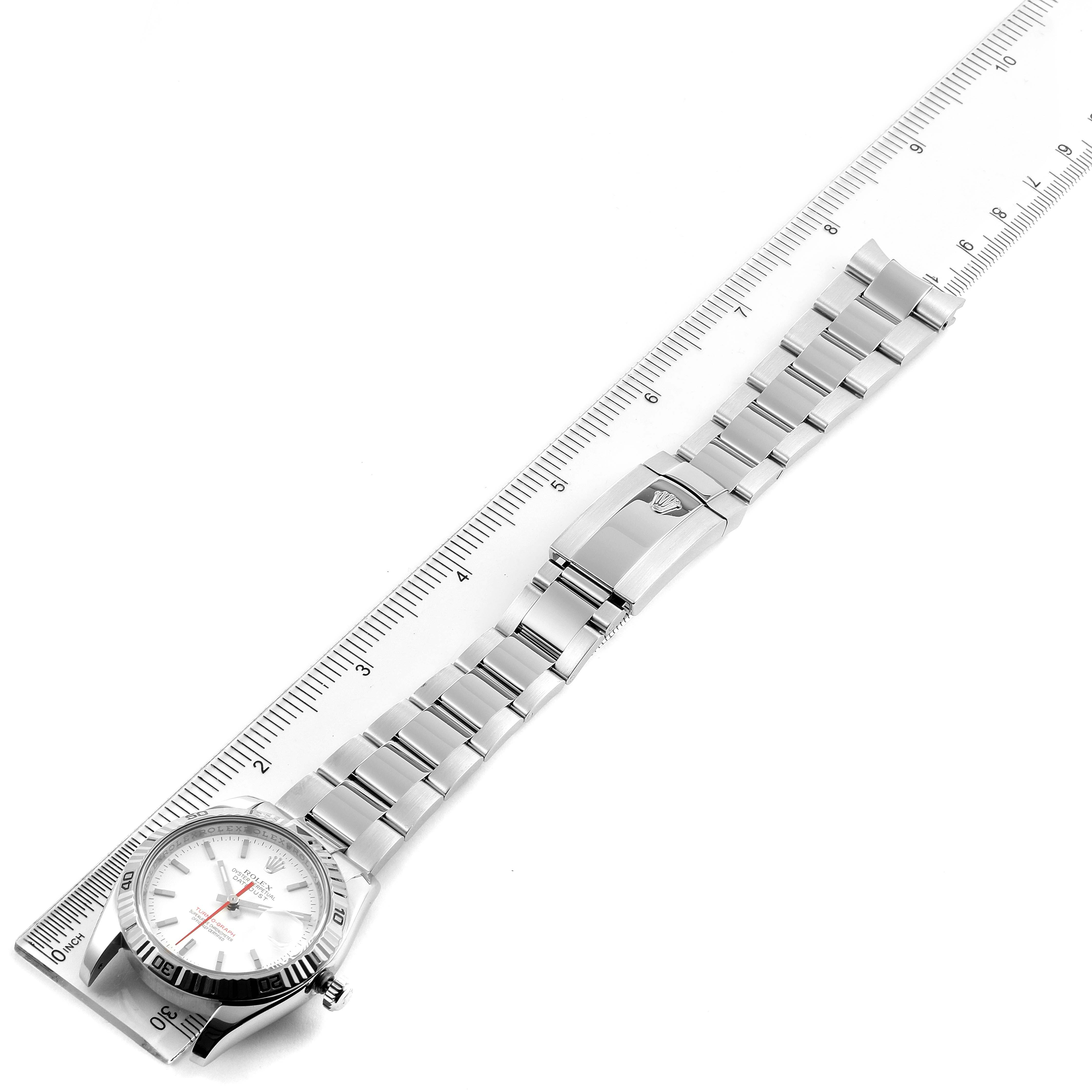 The Rolex Turn-o-Graph 116264 Men
s Stainless Steel White Dial 116264 Men
s Stainless Steel White Dial watch is shown from a top-down angle, featuring its full bracelet and clasp, with a ruler for measurement.