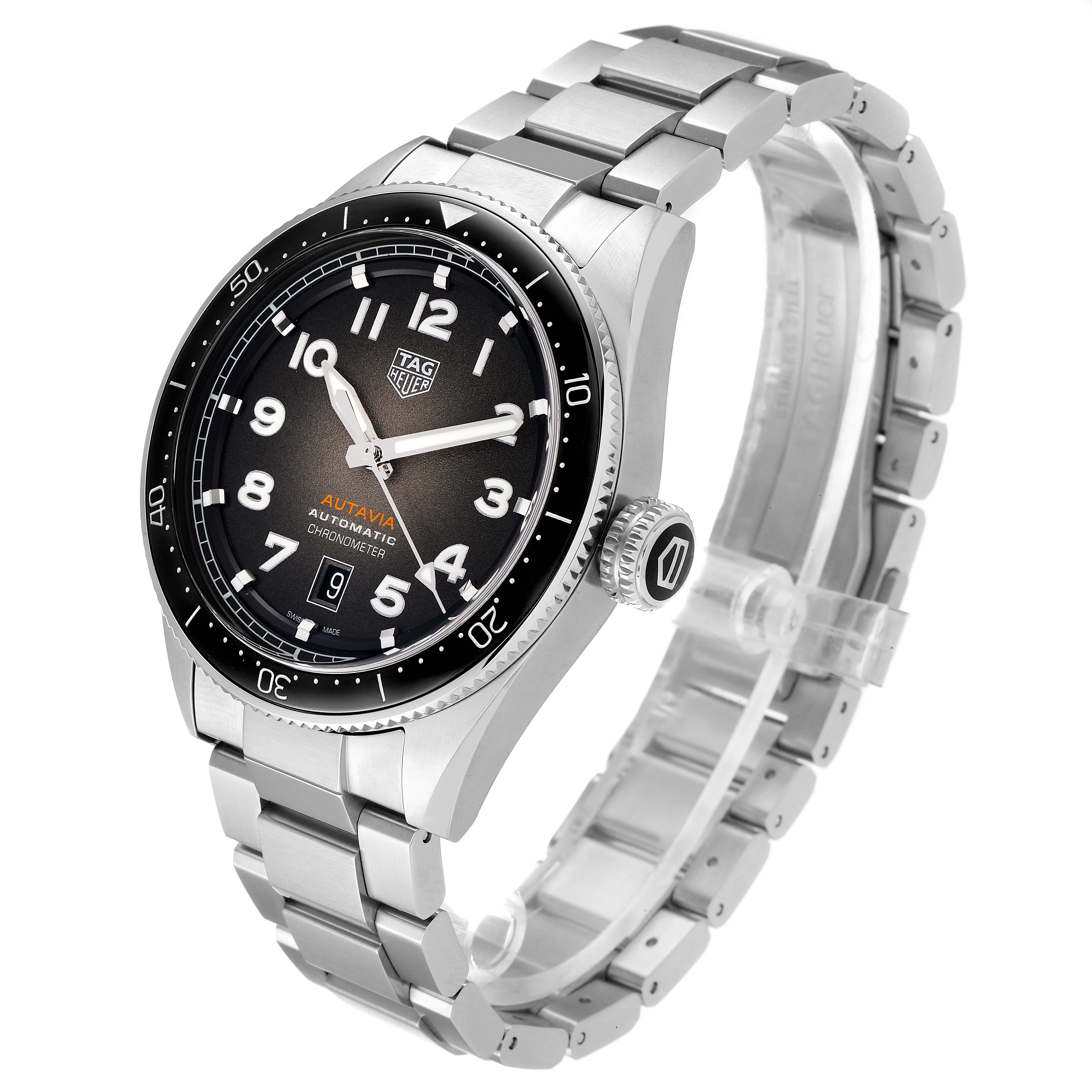 The image shows a three-quarter view of the Tag Heuer Autavia WBE5114.EB0173 Men's Stainless Steel Brown Dial WBE5114.EB0173 Men's Stainless Steel Brown Dial watch, highlighting the face, bezel, crown, and stainless steel bracelet.