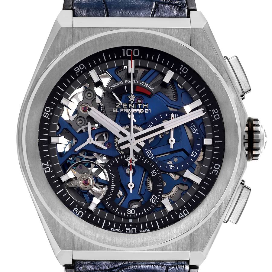 The Zenith El Primero watch is shown from the front, highlighting its intricate dial and skeletonized movement.