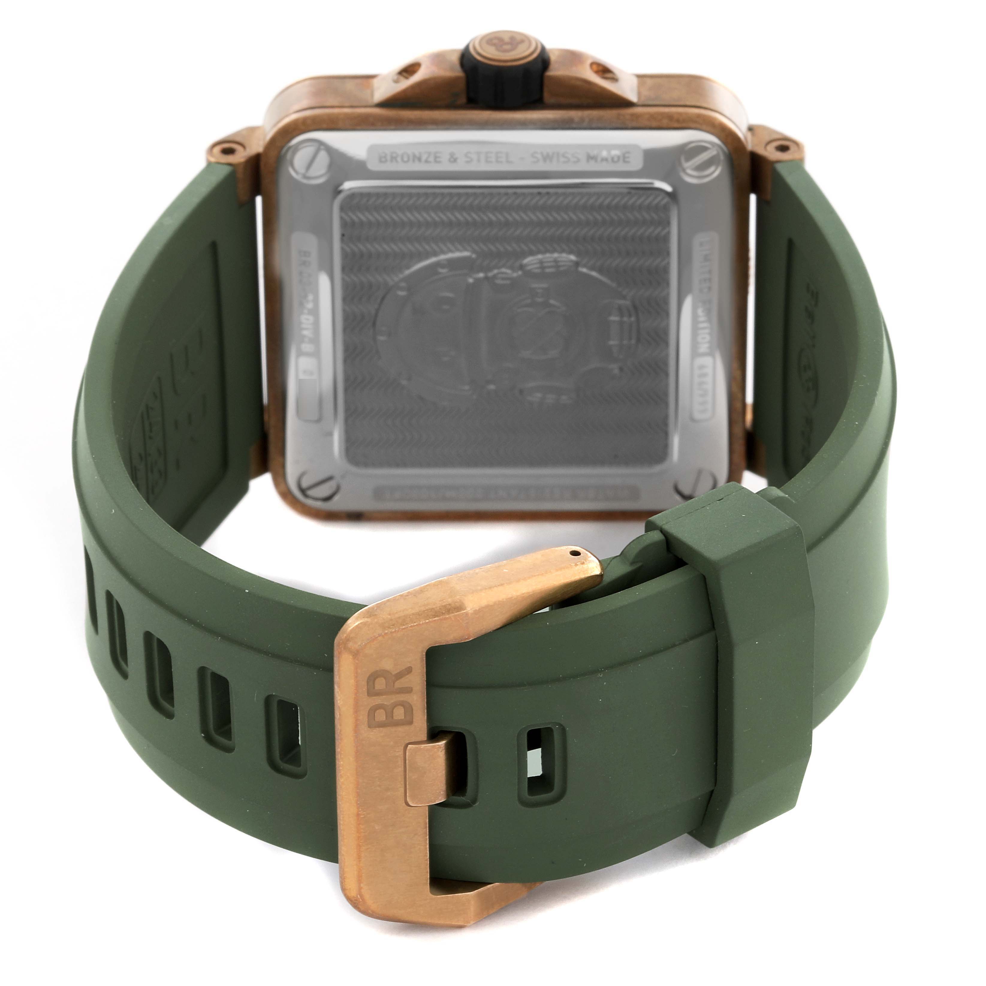 The image shows the back of a Bell 
Ross Instruments BR03-92-DIV-B Men
s Bronze Green Dial BR03-92-DIV-B Men
s Bronze Green Dial watch case and green strap with a bronze buckle.