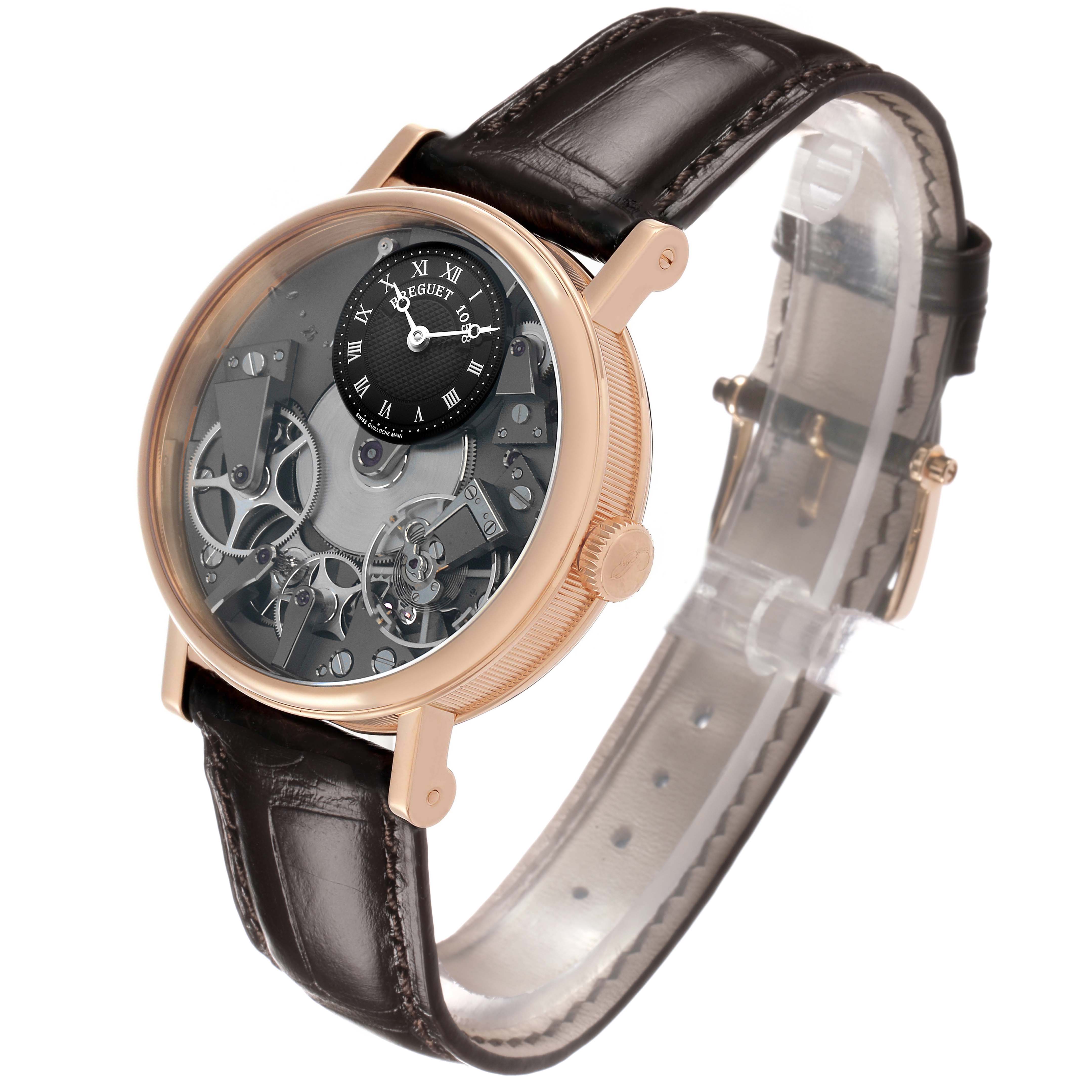 The Breguet Tradition 7027 Men's Rose Gold Grey Dial watch is shown at a slight angle, highlighting its mechanical movement and leather strap.