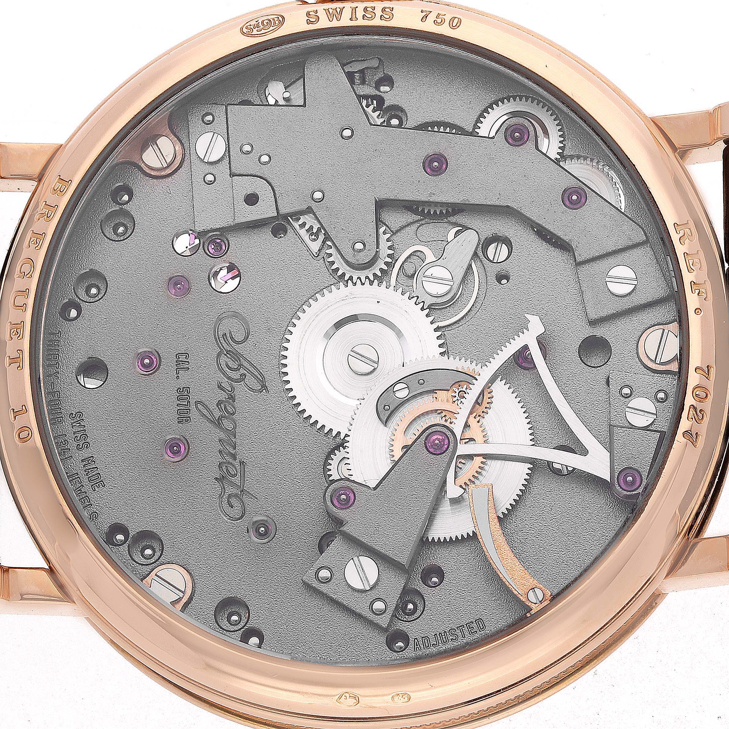 The image shows the back view of the Breguet Tradition 7027 Men's Rose Gold Grey Dial watch, highlighting its intricate movement and gears.
