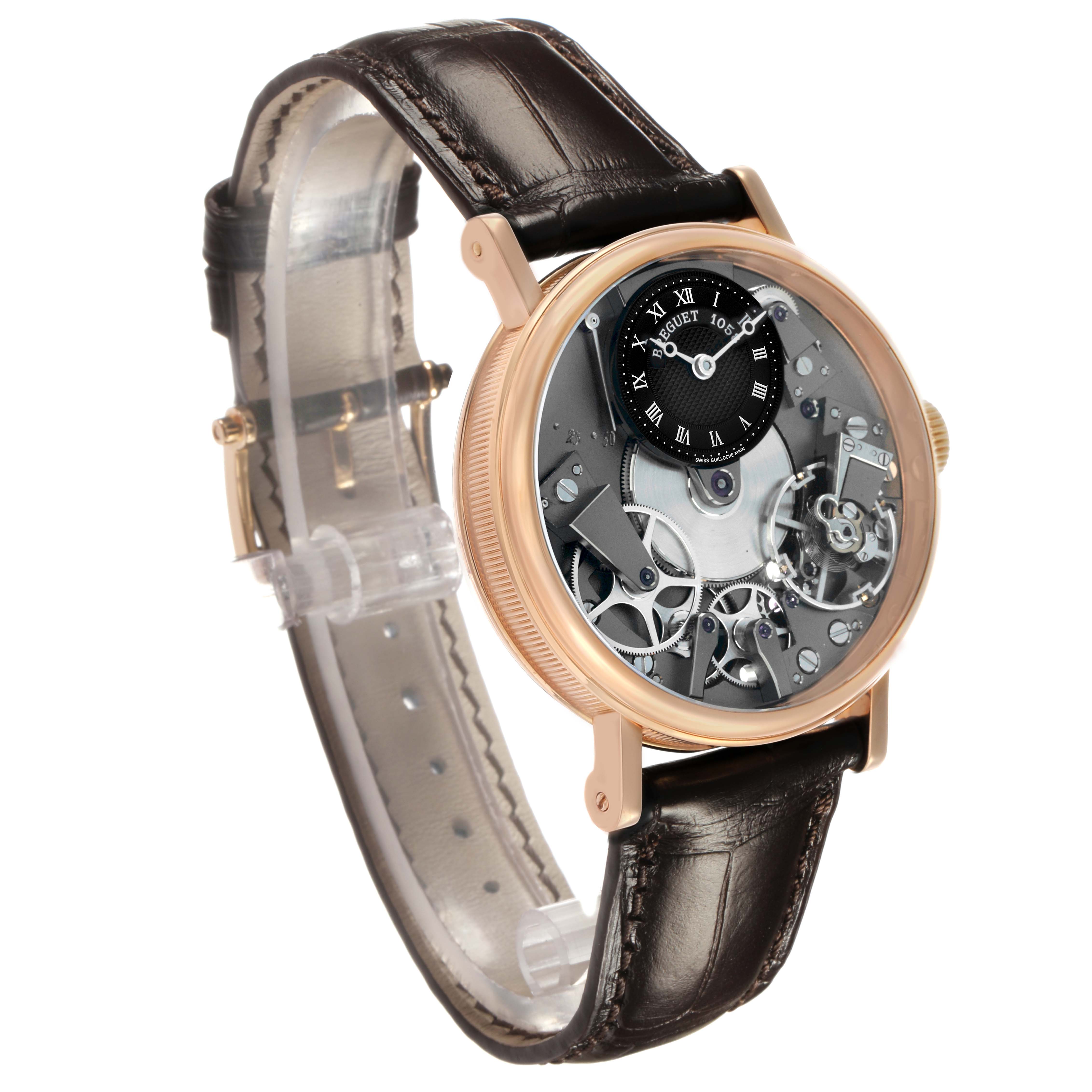 The Breguet Tradition 7027 Men's Rose Gold Grey Dial watch is shown at an angle displaying its open movement, Roman numeral sub-dial, and leather strap.