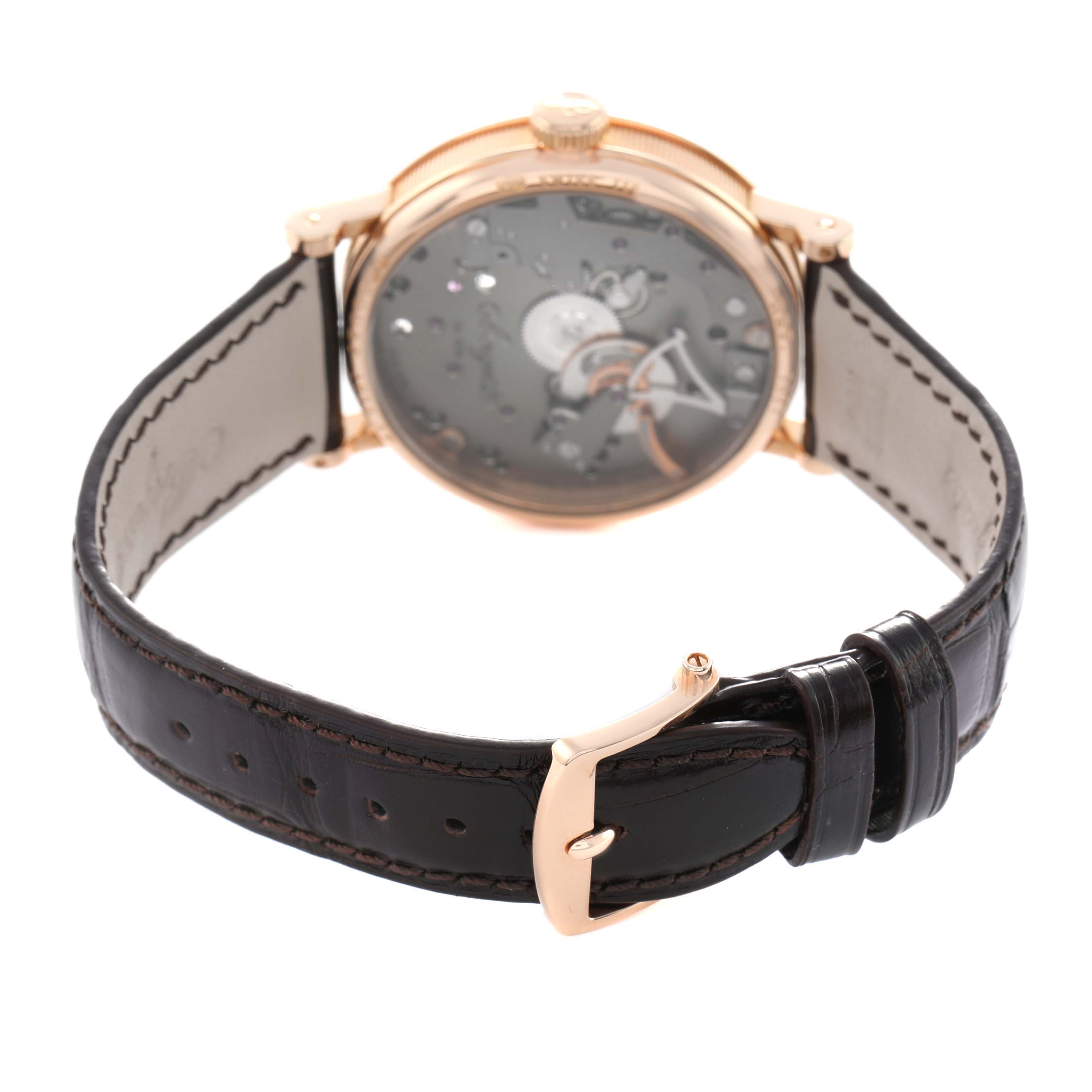 The Breguet Tradition 7027 Men's Rose Gold Grey Dial watch is shown from a rear perspective, highlighting the strap, buckle, and partially visible dial.