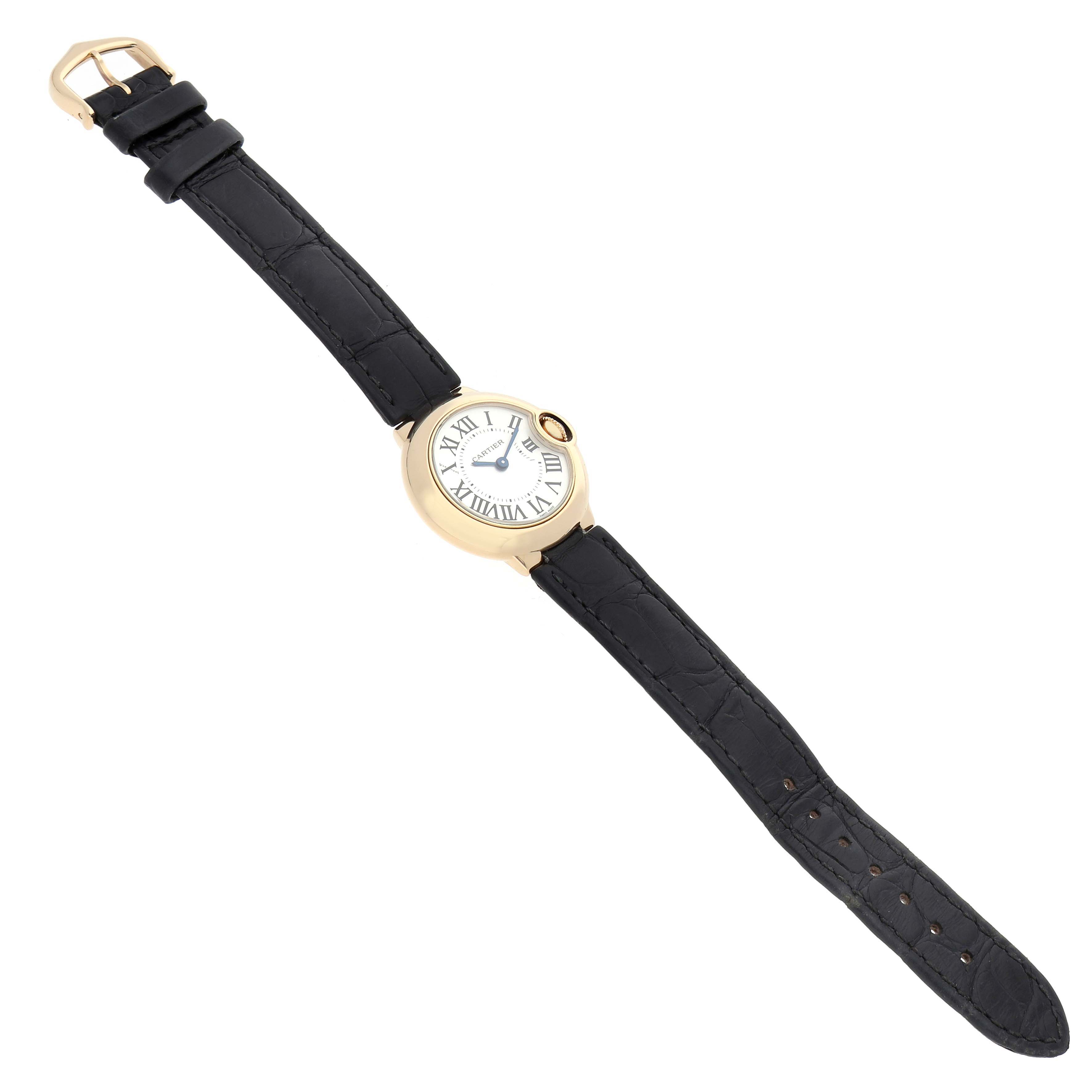 The Cartier Ballon Bleu W6900156 Women's Yellow Gold Silver Dial watch is shown at a top-down angle, displaying the face, case, and black leather strap.