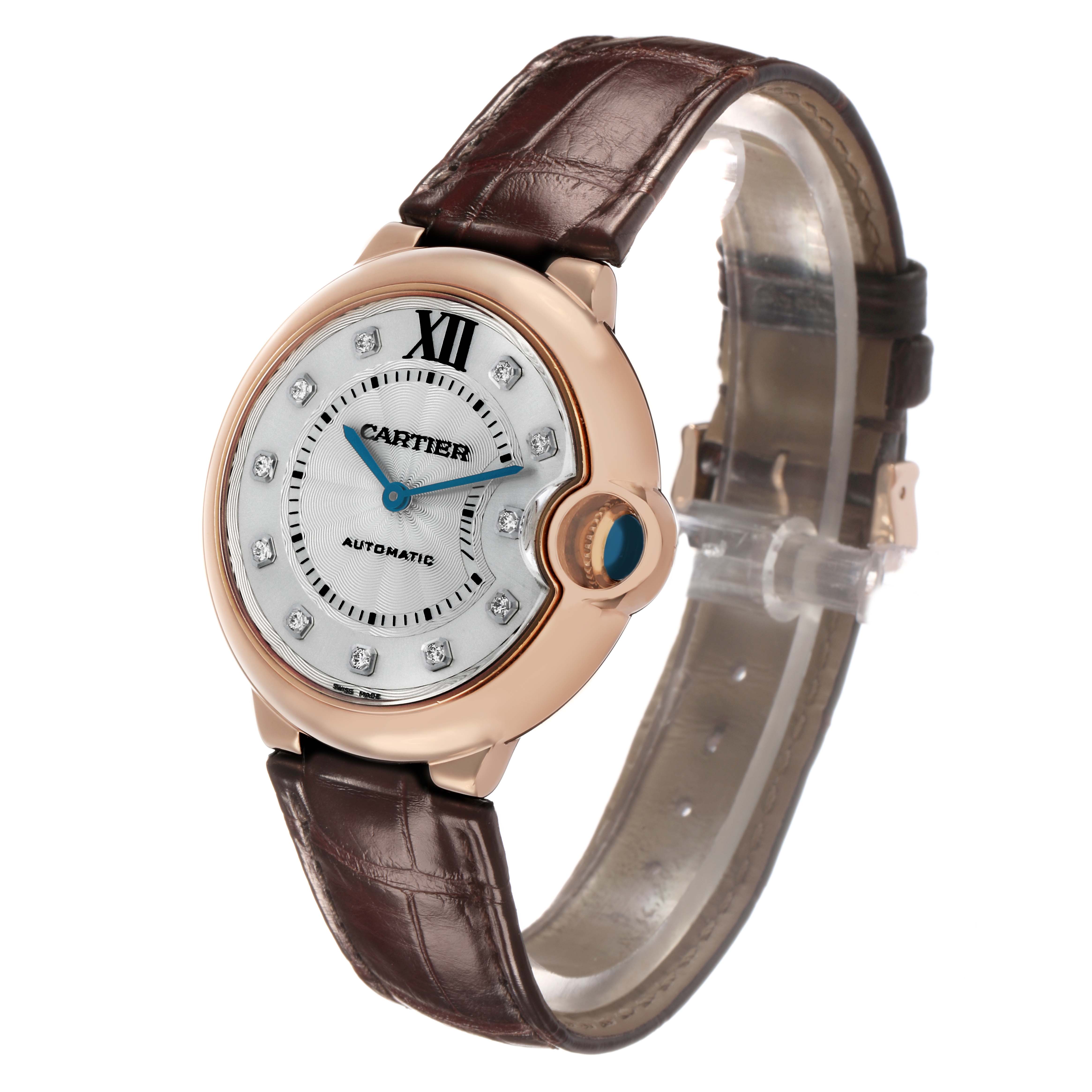 The Cartier Ballon Bleu WJBB0010 Women's Rose Gold Silver Dial watch is shown from a three-quarter front angle, displaying the face, crown, and leather strap.