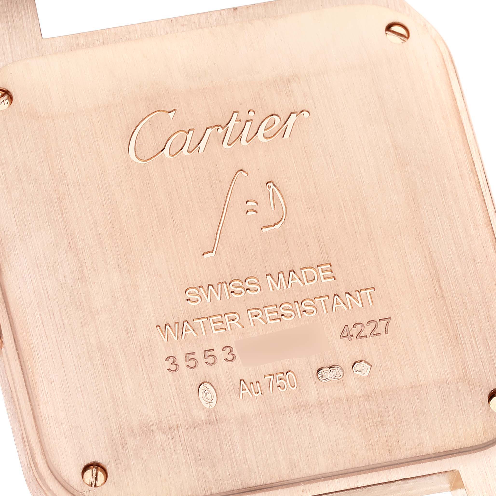The image shows the engraved back of a Santos Dumont model by Cartier, displaying branding and specifications.