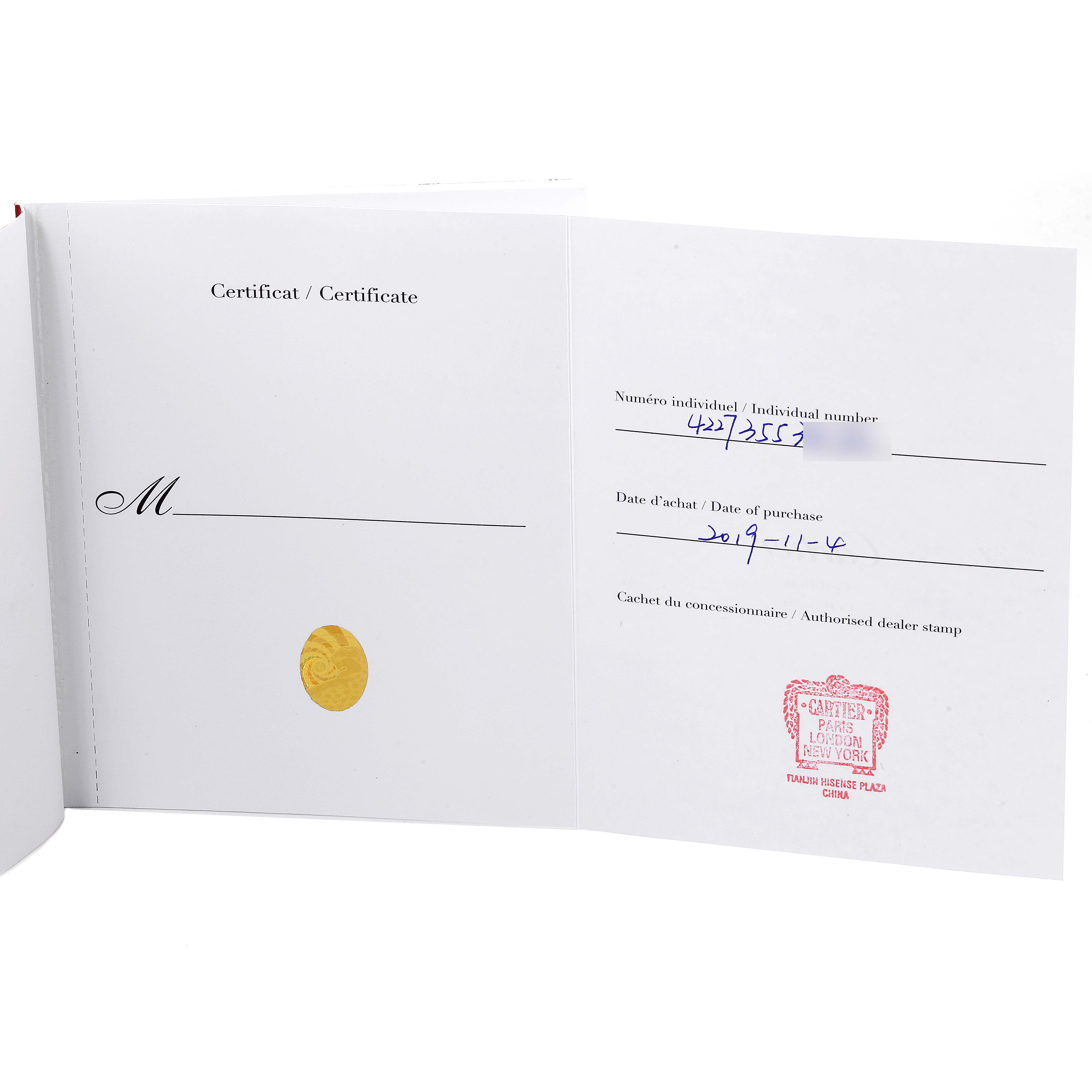 The image shows the open certificate booklet for the Santos Dumont model by Cartier, displaying individual number and purchase date.