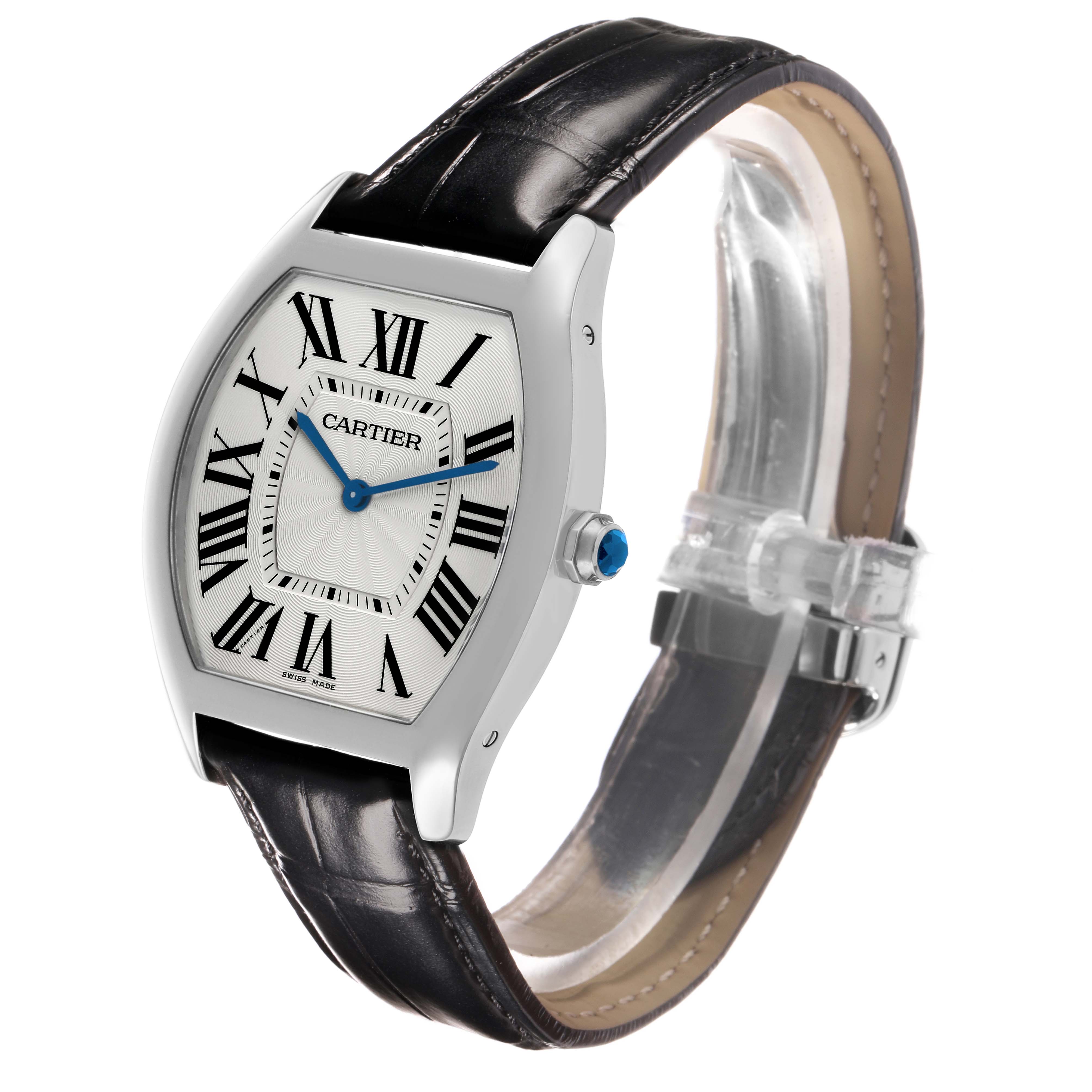 The Cartier Tortue WGTO0003 Men's White Gold Silver Dial watch is shown at an angled side view, highlighting its case, Roman numerals, blue hands, crown, and leather strap.