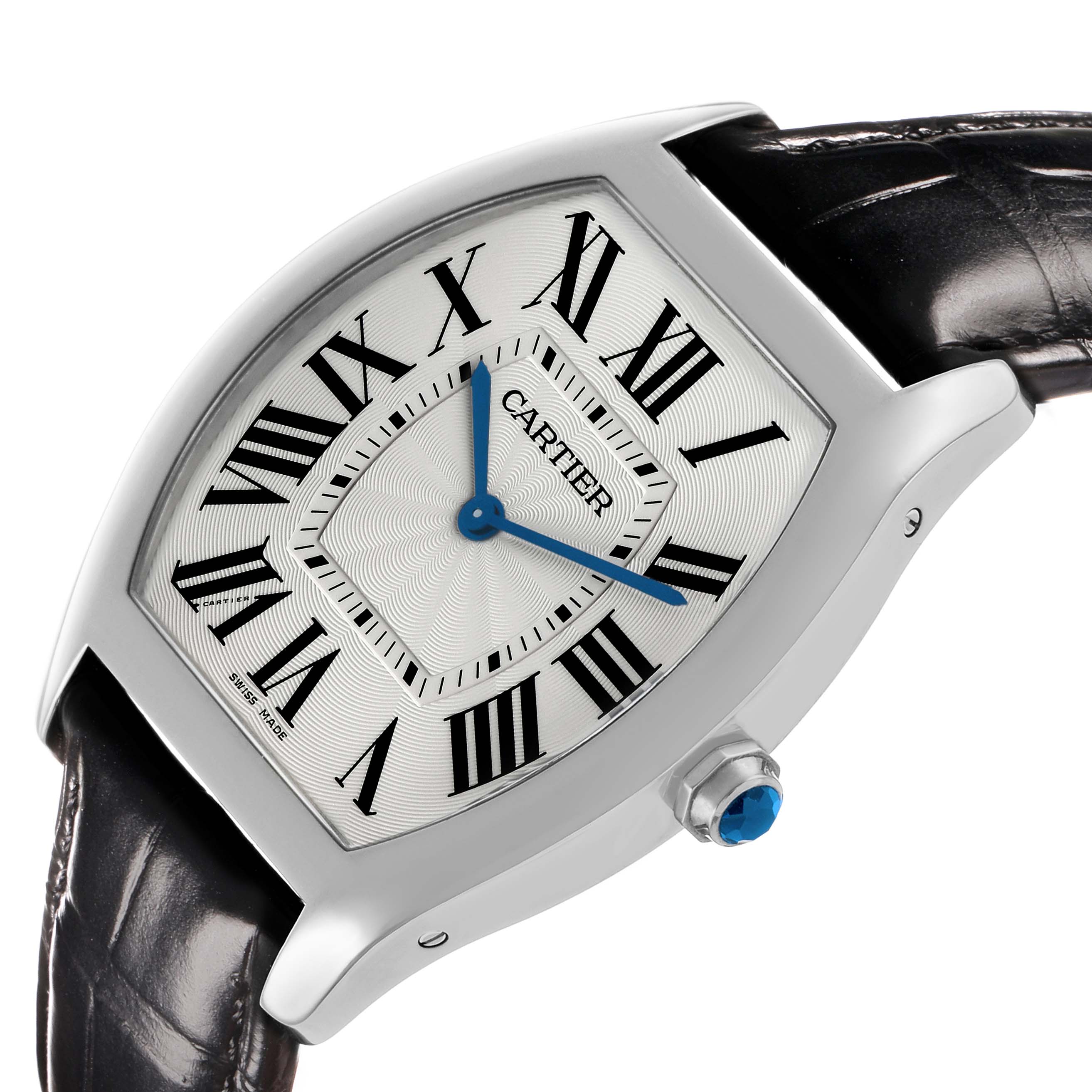 The Cartier Tortue WGTO0003 Men's White Gold Silver Dial watch is shown at an angle highlighting its face, Roman numerals, blue hands, crown, and black leather strap.