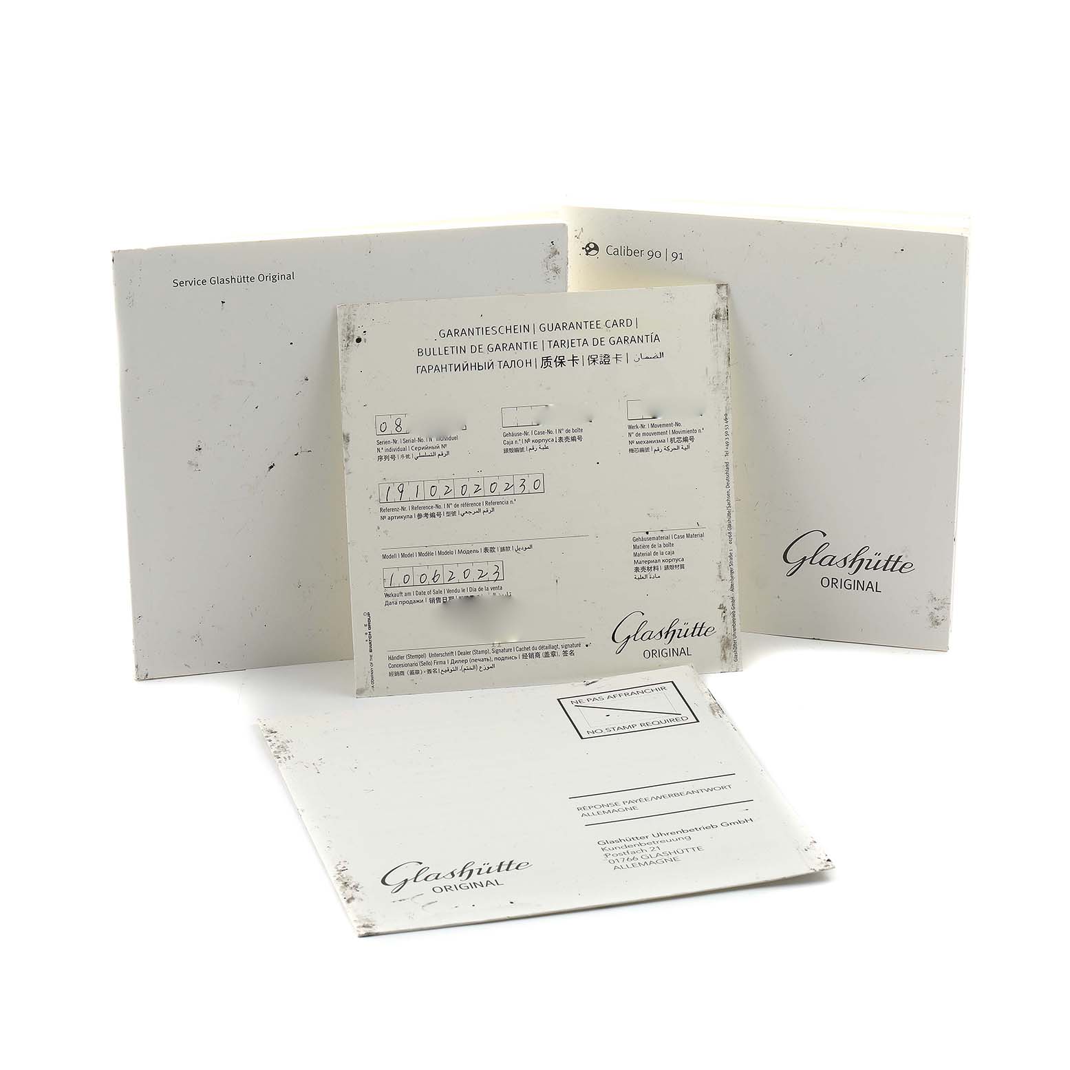 The image shows warranty and service documents for the Glashütte Pano model, displayed from a slightly angled view.