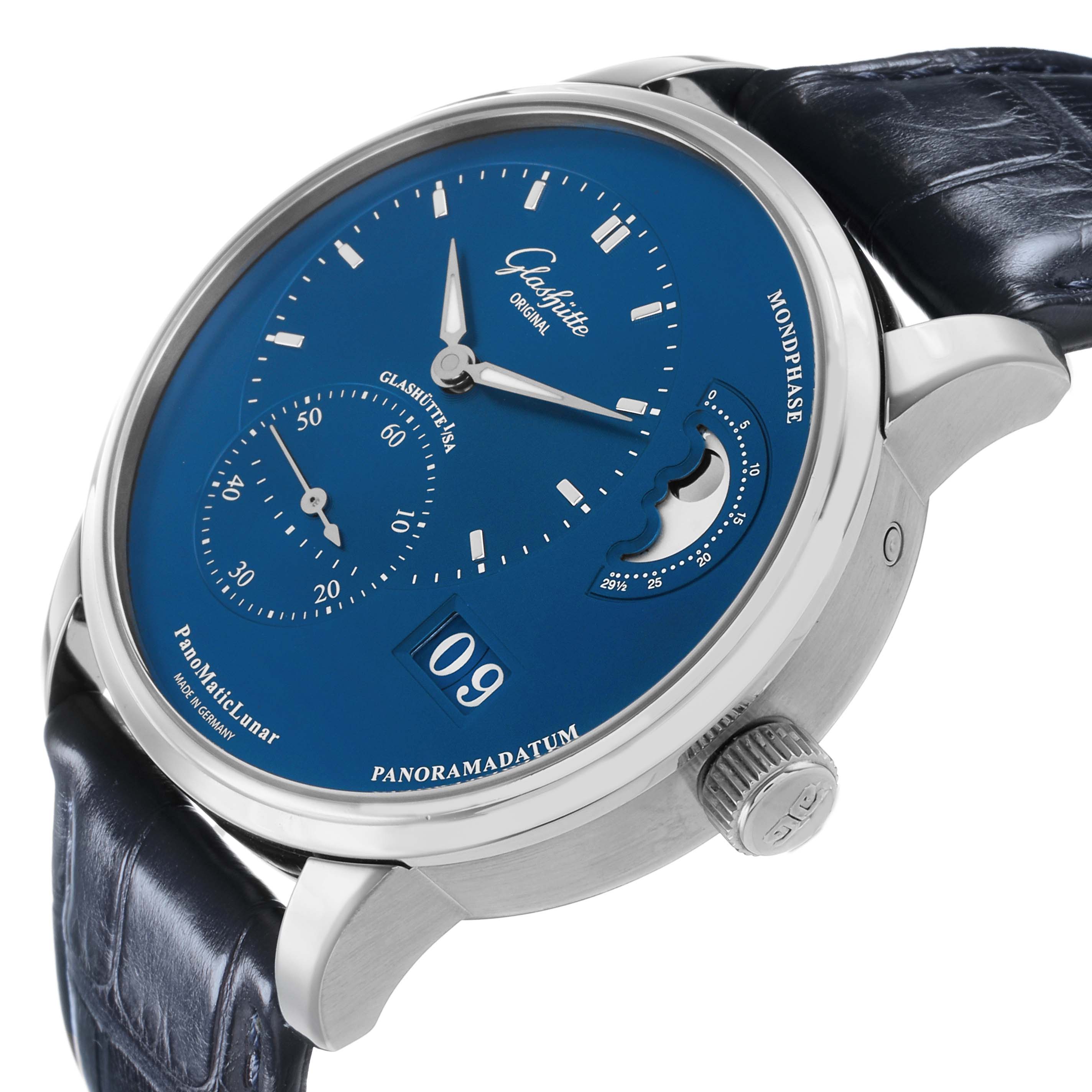 The Glashütte Pano watch is shown at an angle highlighting the blue dial, moonphase, power reserve, and leather strap.