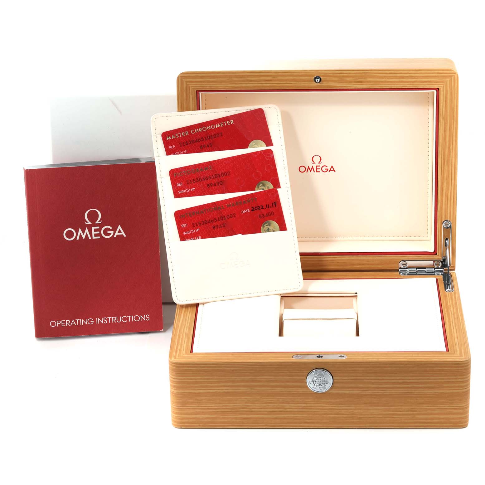 The image shows an Omega Planet Ocean 215.30.46.51.01.002 Men
s Stainless Steel Black Dial 215.30.46.51.01.002 Men
s Stainless Steel Black Dial watch box, warranty cards, and the watch
s operating instructions from a front angle.