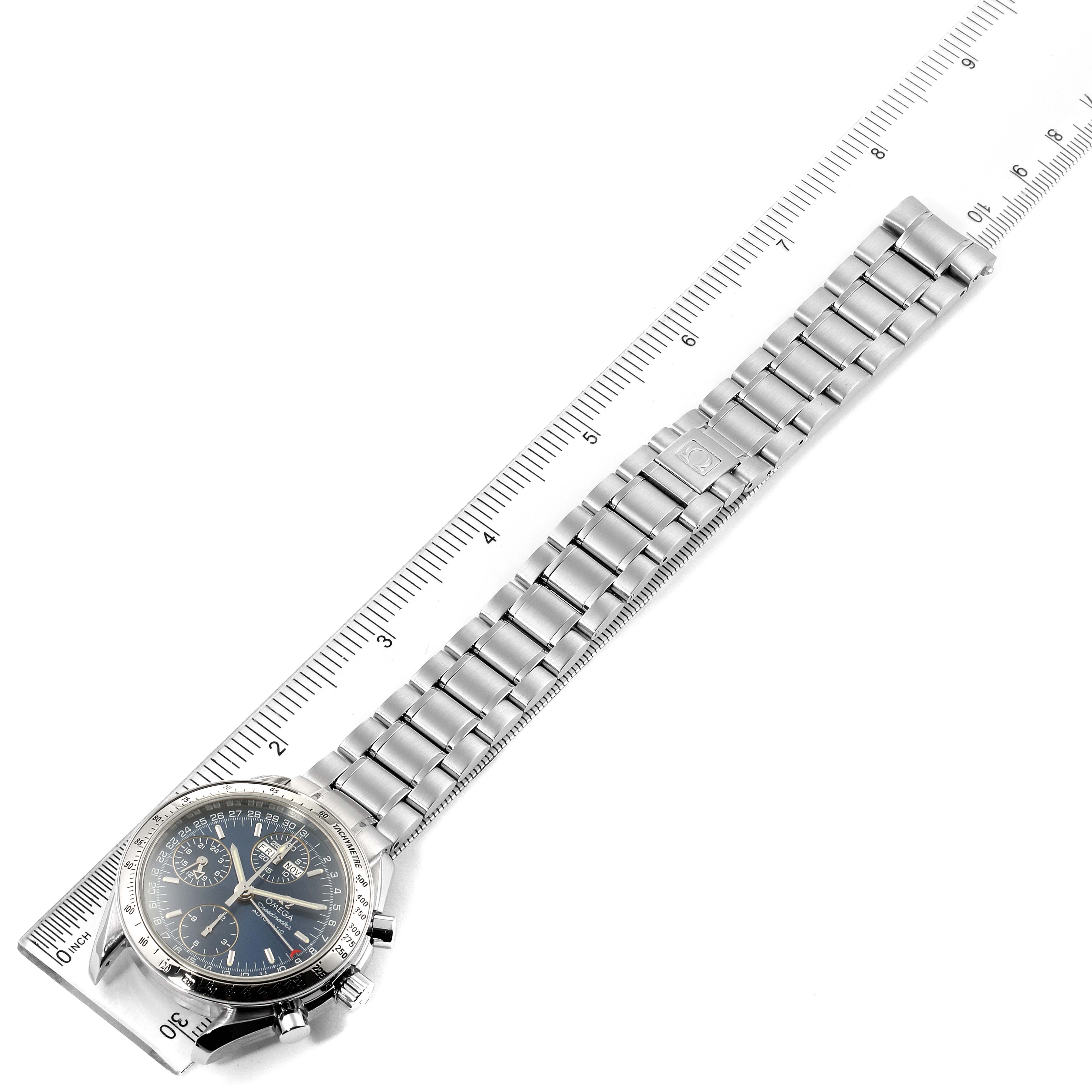 The Omega Speedmaster 3521.80.00 Men
s Stainless Steel Blue Dial 3521.80.00 Men
s Stainless Steel Blue Dial watch is photographed flat from overhead, showing the face, bezel, case, and full bracelet against a ruler.