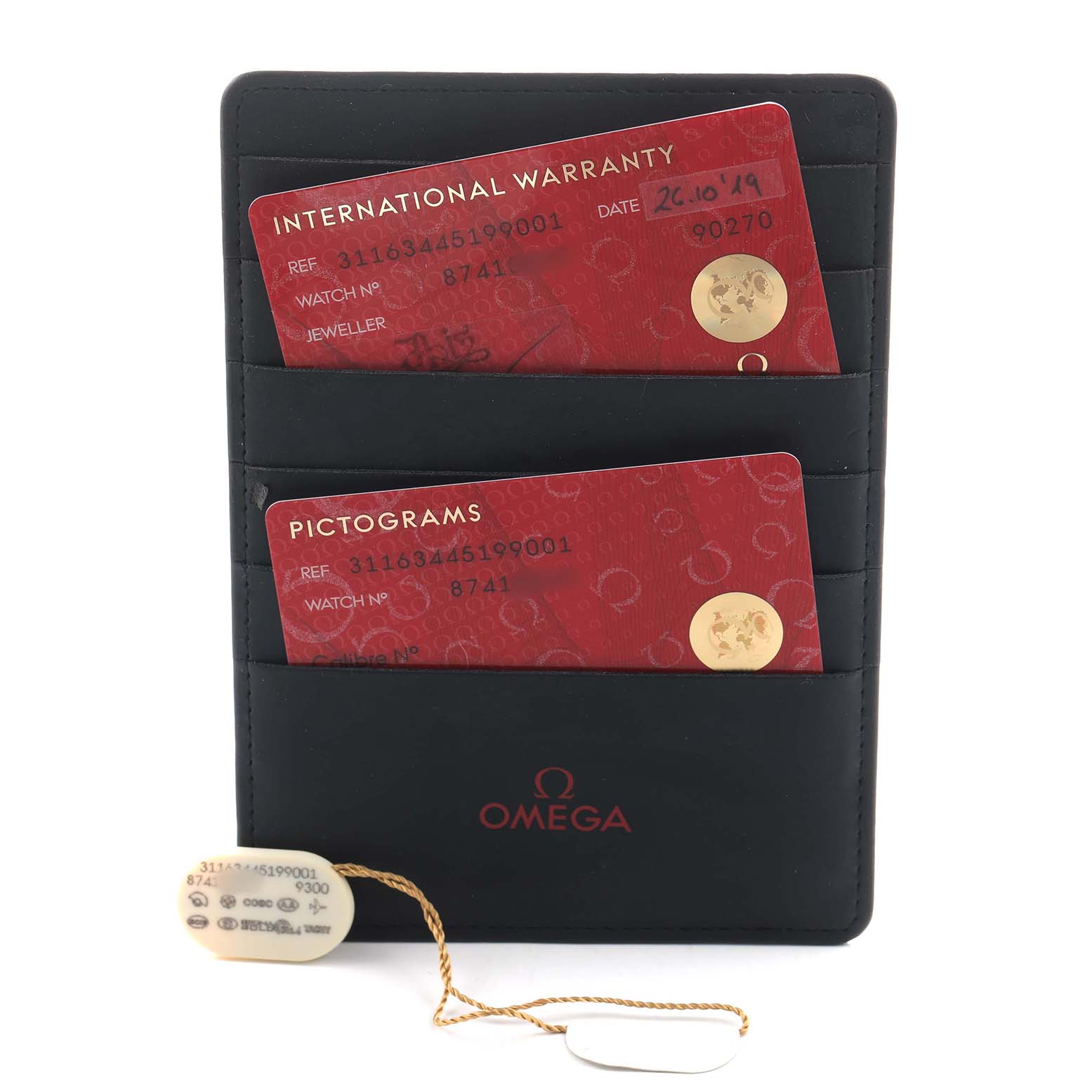 The image shows Omega Speedmaster 311.63.44.51.99.001 Men's Ceramic Grey Dial warranty and pictogram cards in a black holder with the Omega logo and a hangtag.