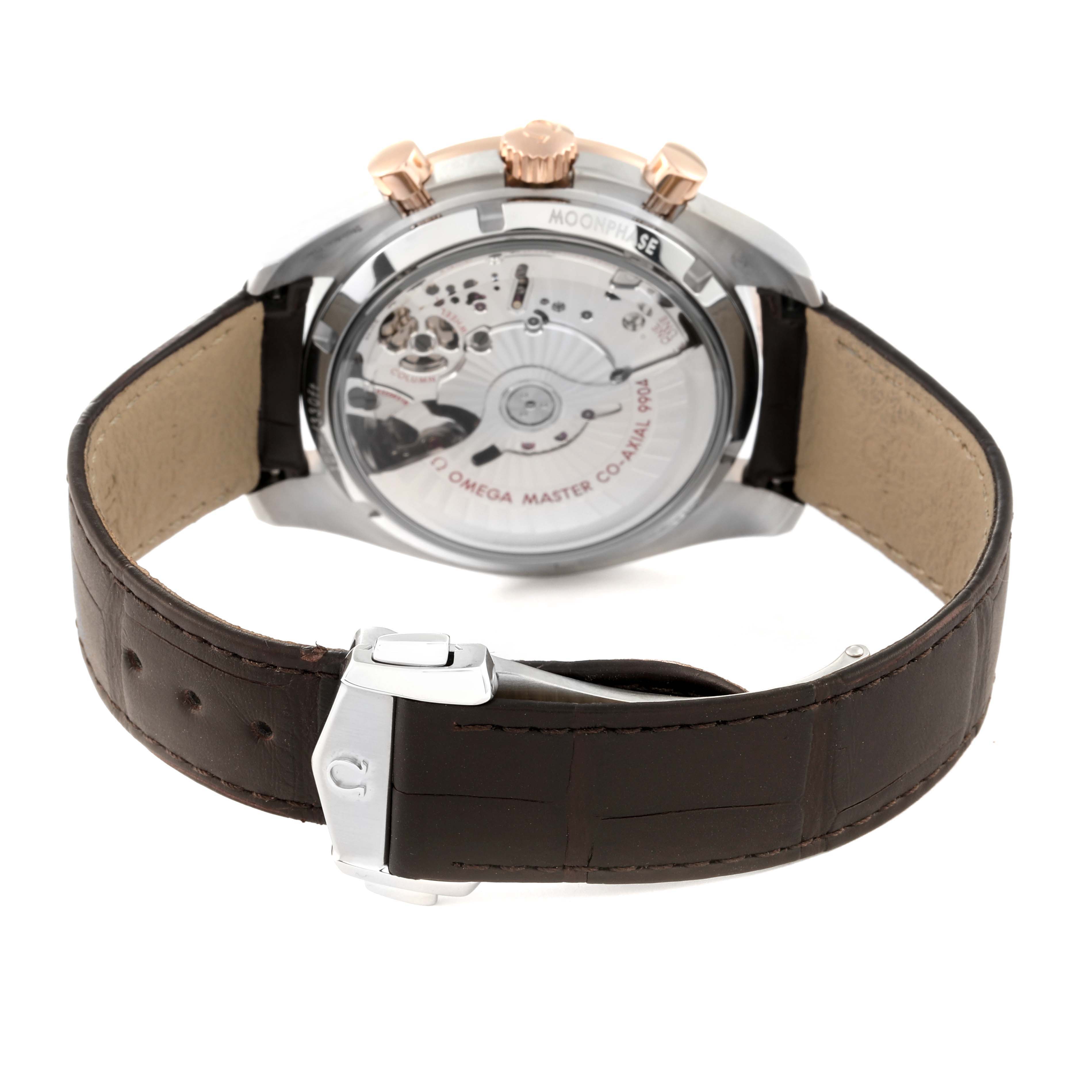 The image shows the back of the Omega Speedmaster 304.23.44.52.13.001 Men's Stainless Steel Brown Dial 304.23.44.52.13.001 Men's Stainless Steel Brown Dial watch, highlighting its transparent case back, movement, and leather strap with clasp.