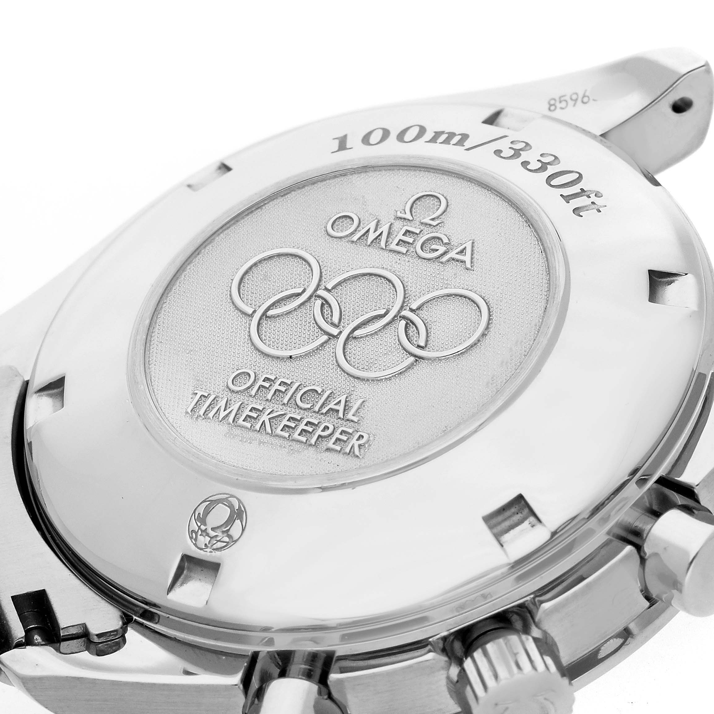 The image shows the back case of an Omega Speedmaster 323.10.40.40.04.001 Men's Stainless Steel White Dial, highlighting the "Official Timekeeper" engraving and water resistance details.