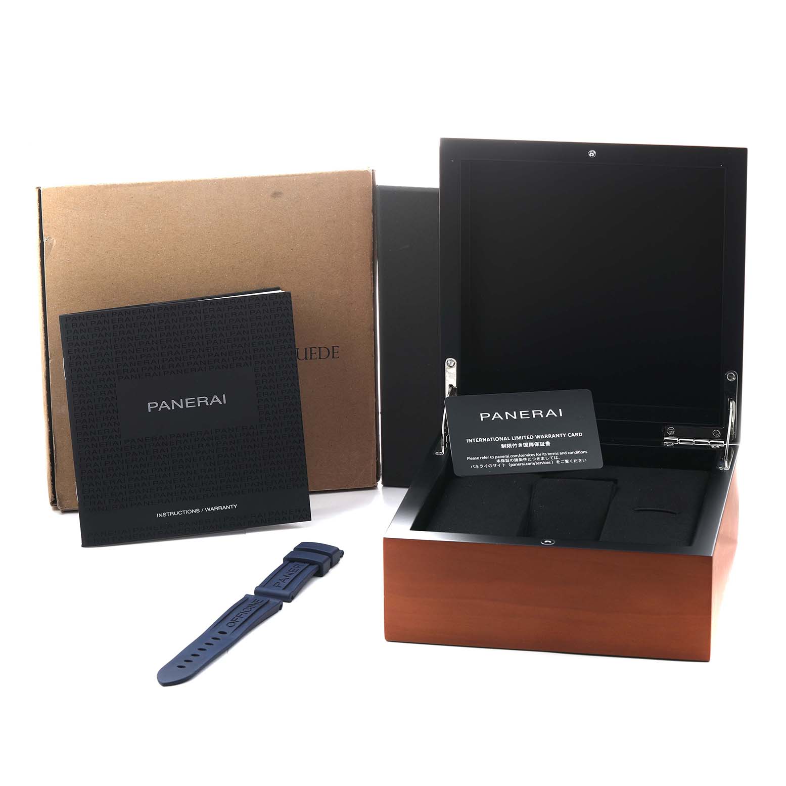 The image shows a Panerai Luminor PAM01370 Men's Stainless Steel Blue Dial watch box, warranty card, blue strap, and manual from a front-side angle.